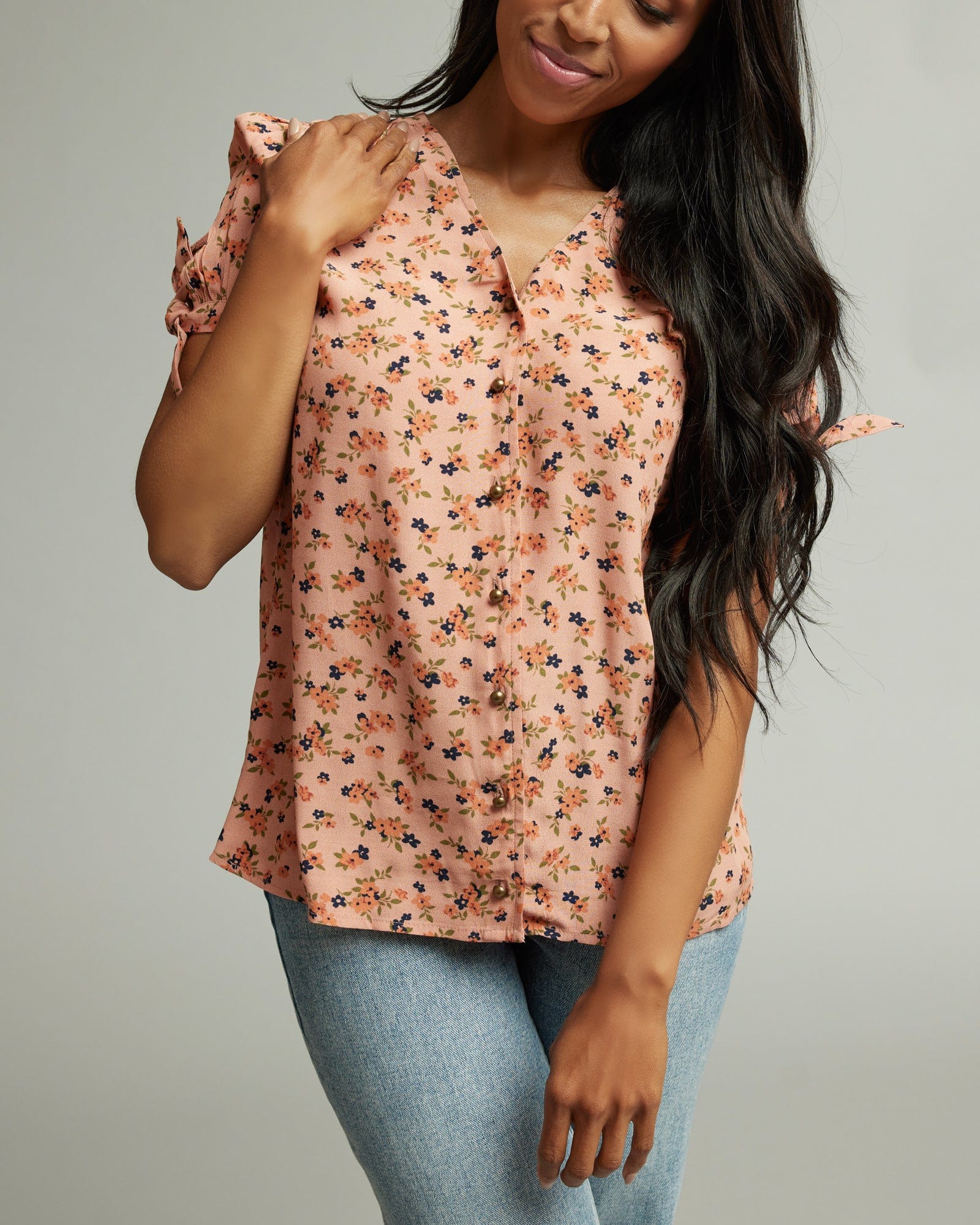 Woman in a short sleeve, pink floral print top