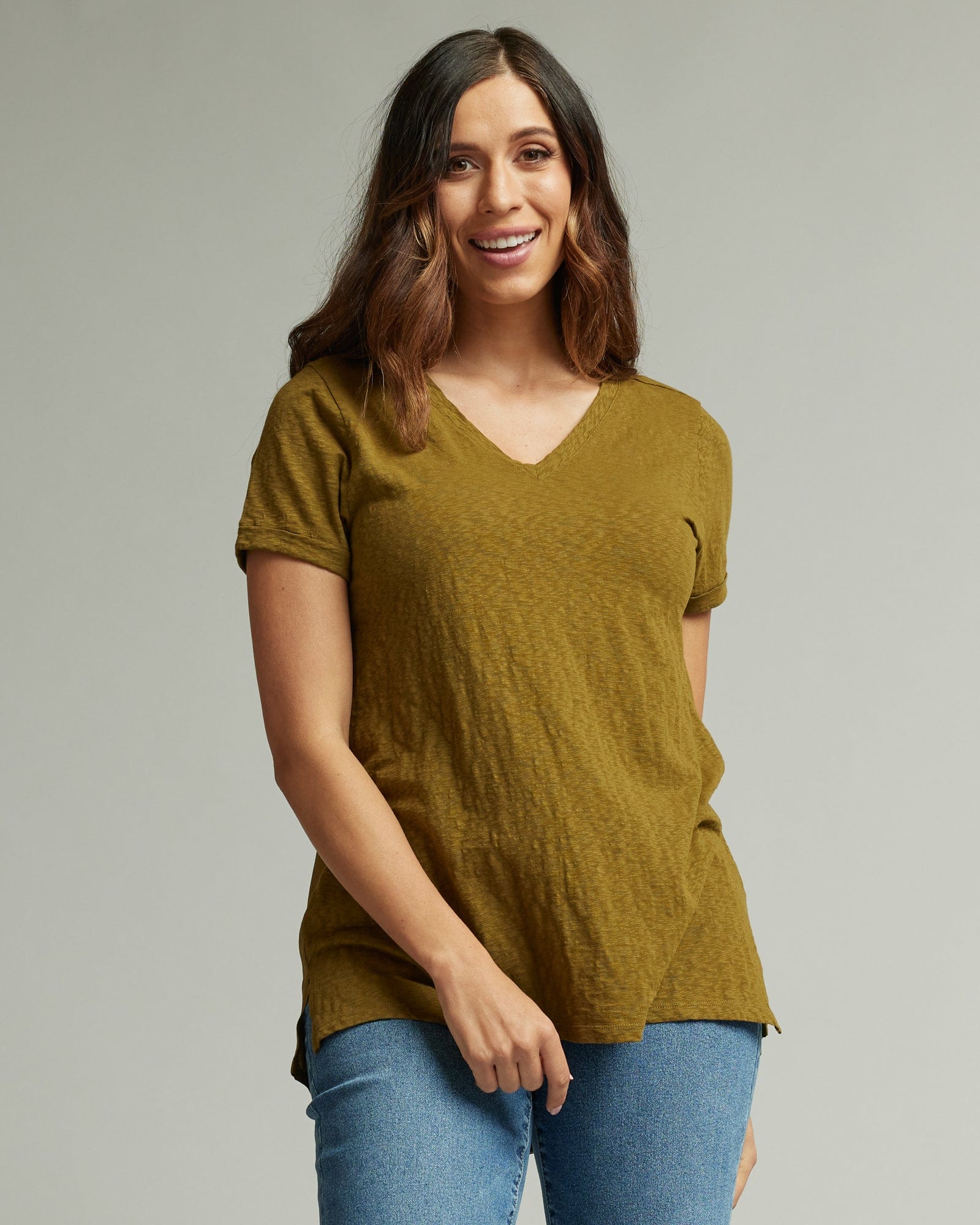 Woman in a short sleeve, v-neck, green blouse