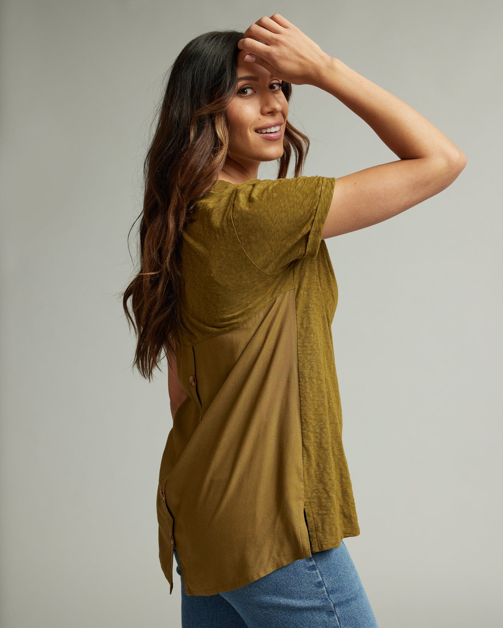 Woman in a short sleeve, v-neck, green blouse