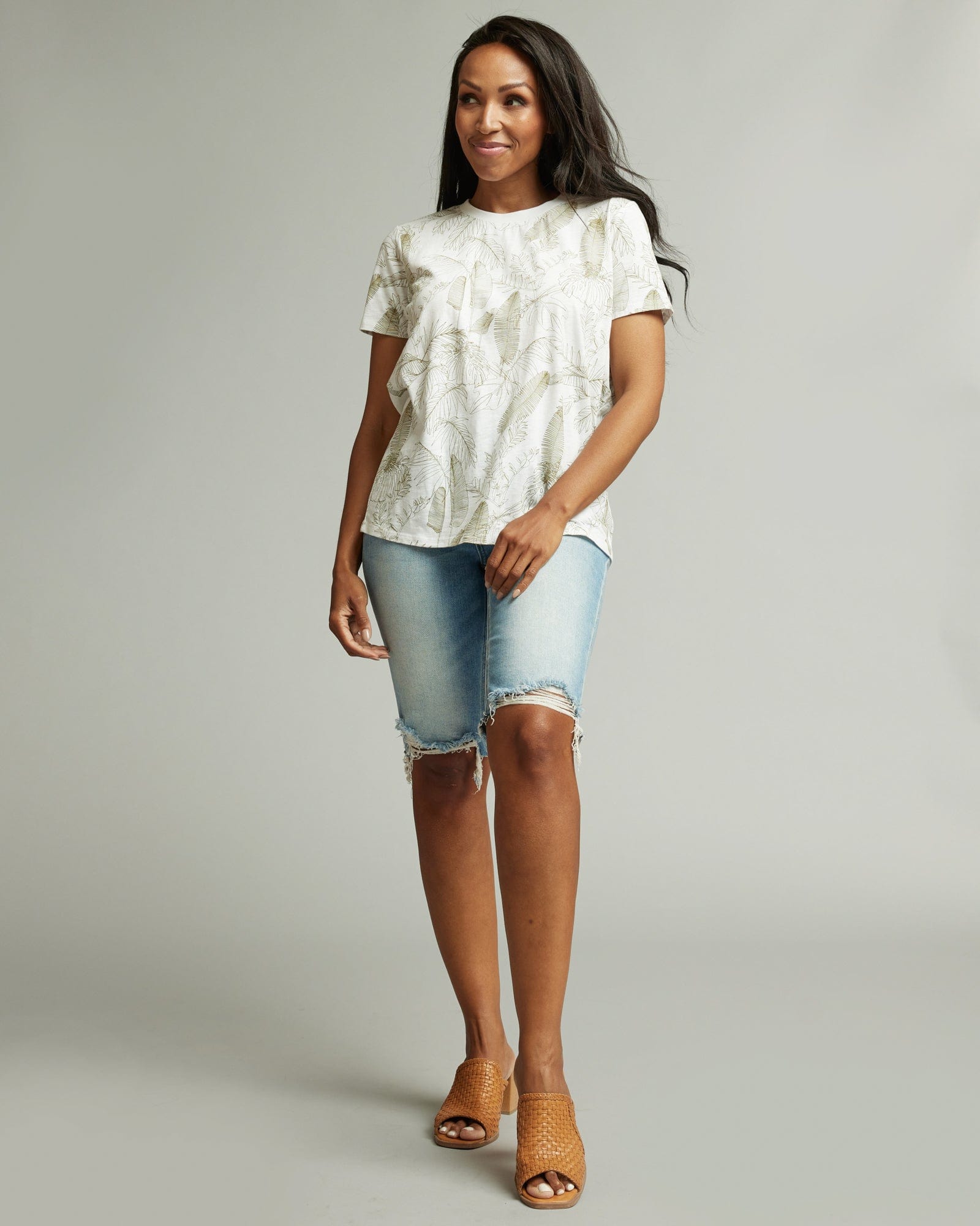 Woman in a short sleeve graphic tee with floral motif all over