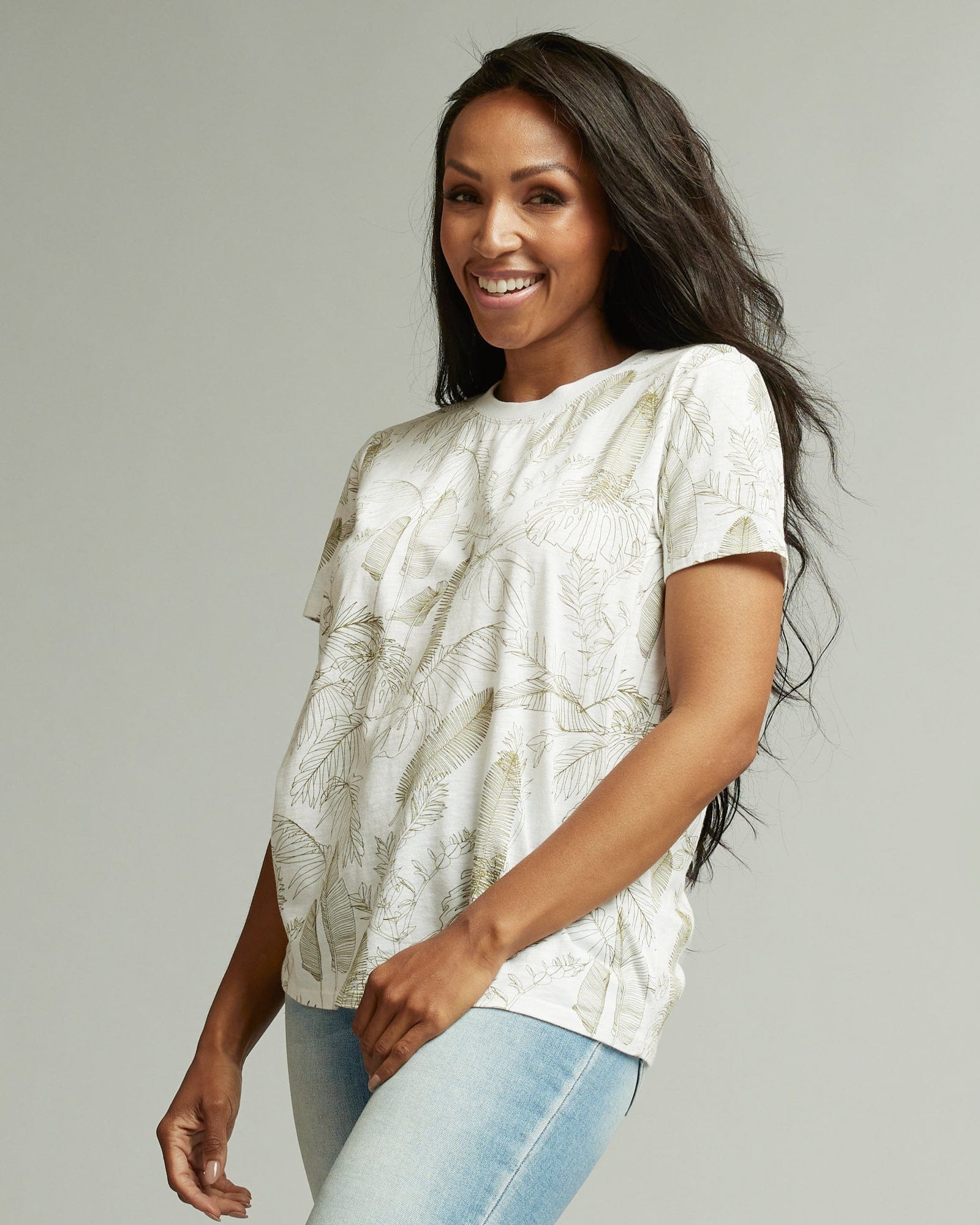Woman in a short sleeve graphic tee with floral motif all over