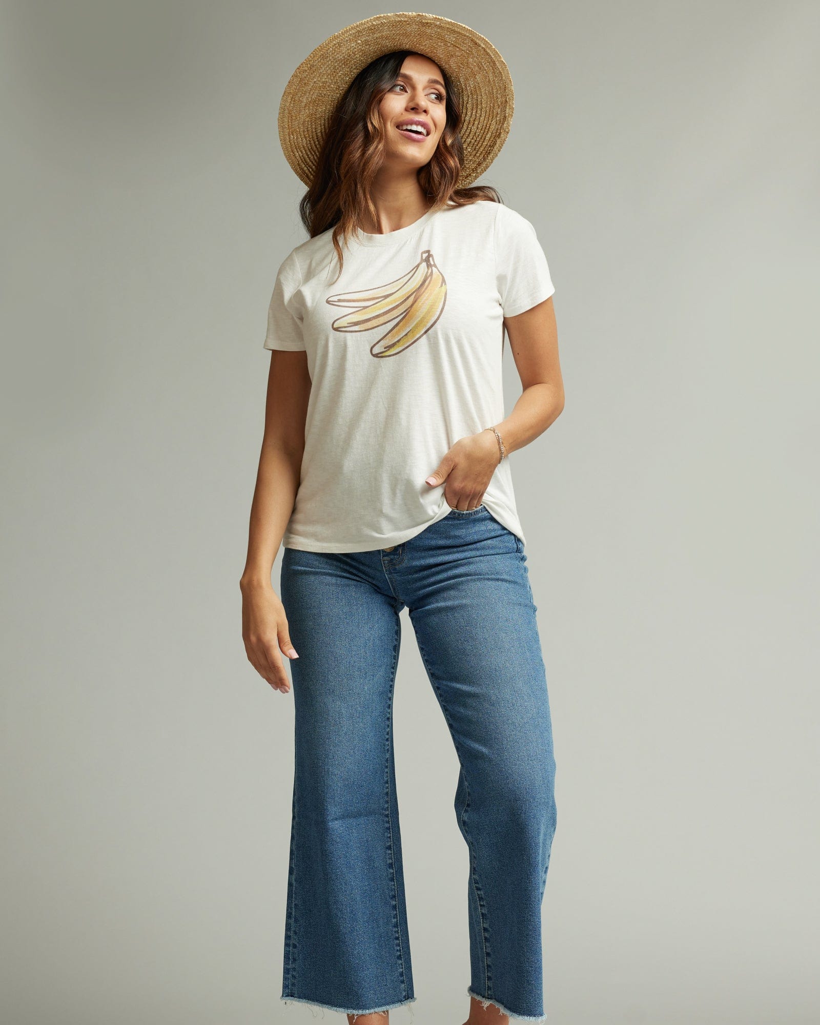Woman in a short sleeve white graphic tee with a banana on the front