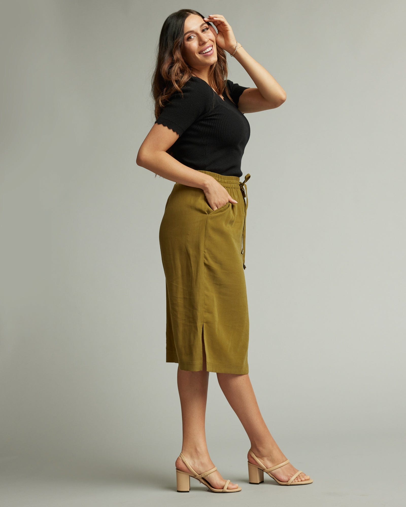 Woman in an olive knee-length skirt
