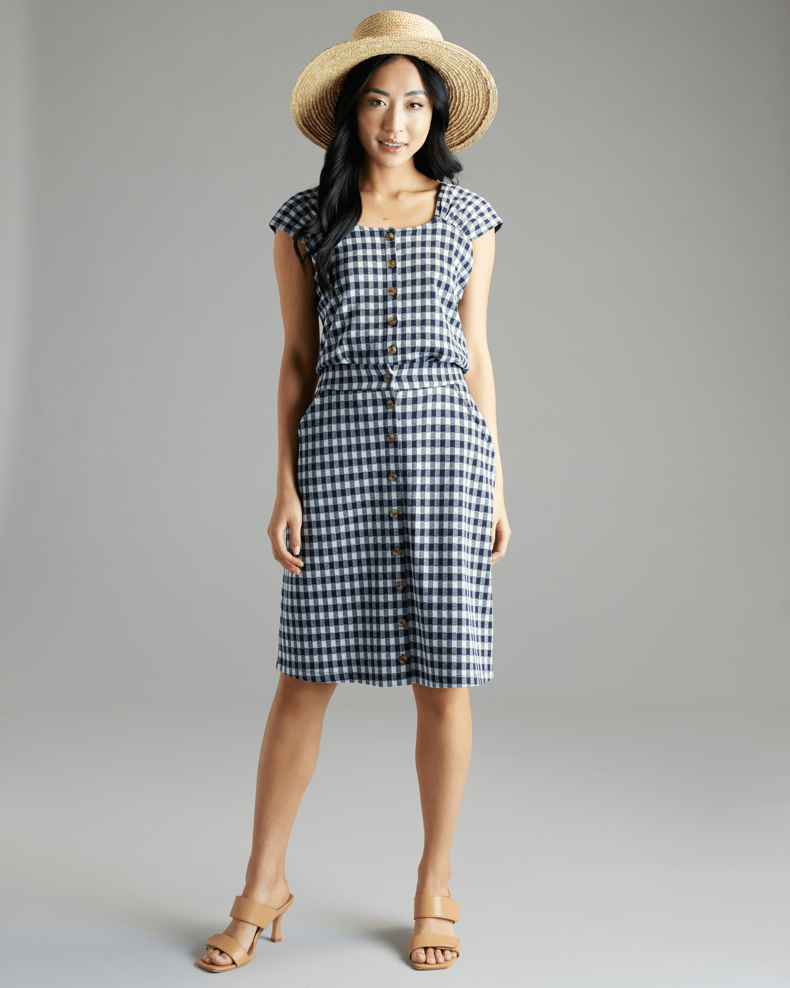 Woman in navy and white gingham knee-length skirt