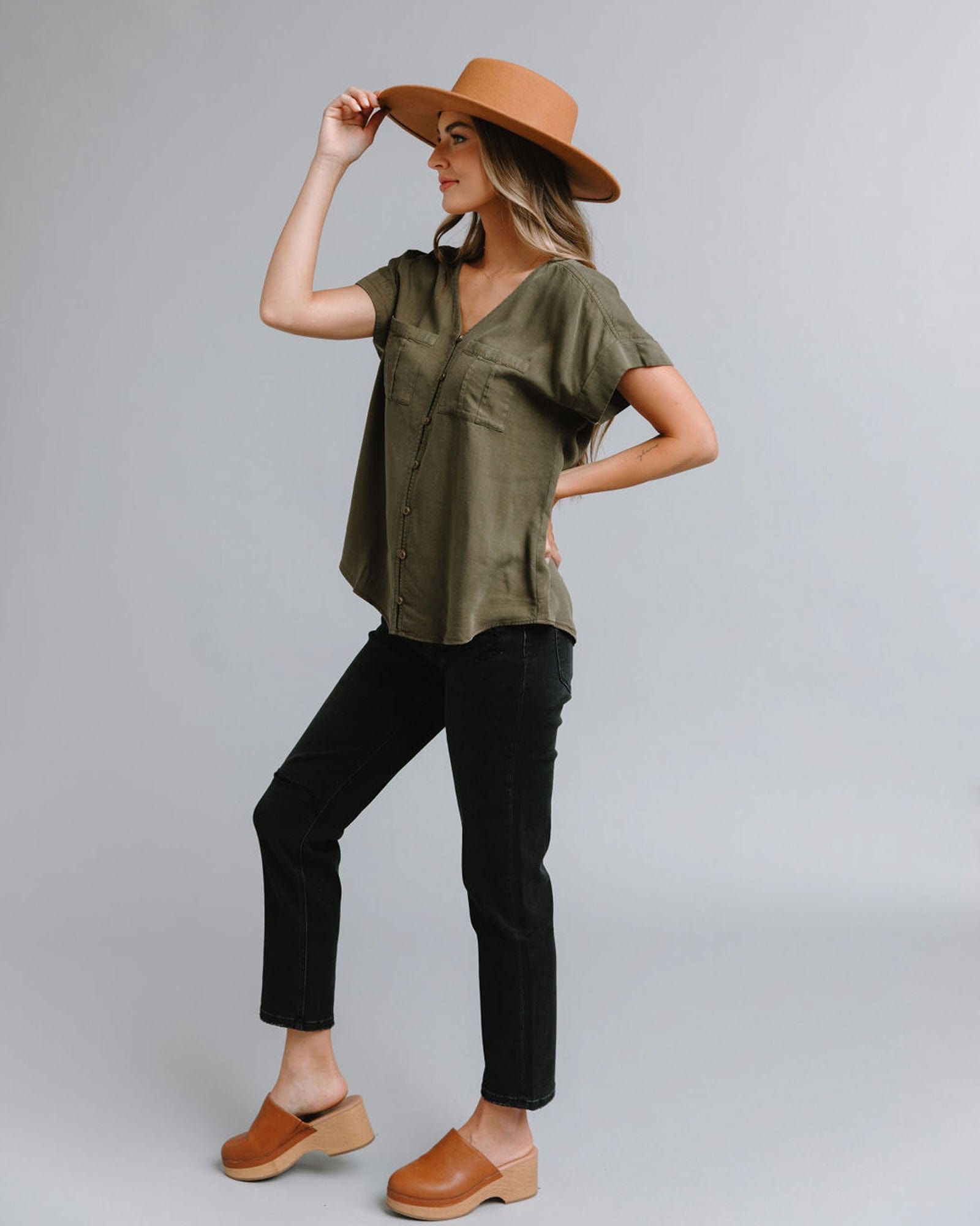 Woman in a short sleeve, v-neck blouse with front seam