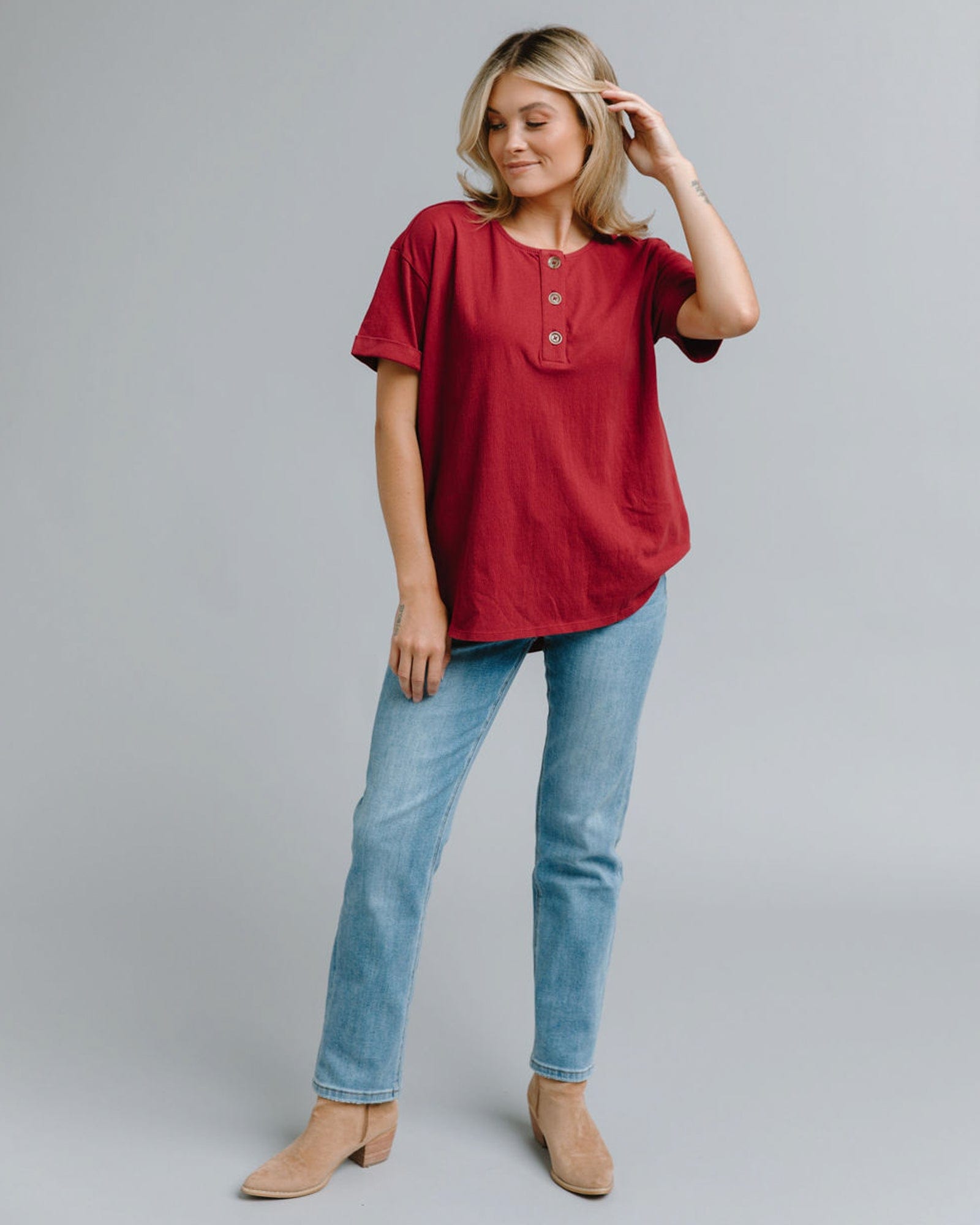 Woman in a short sleeve, henley style blouse