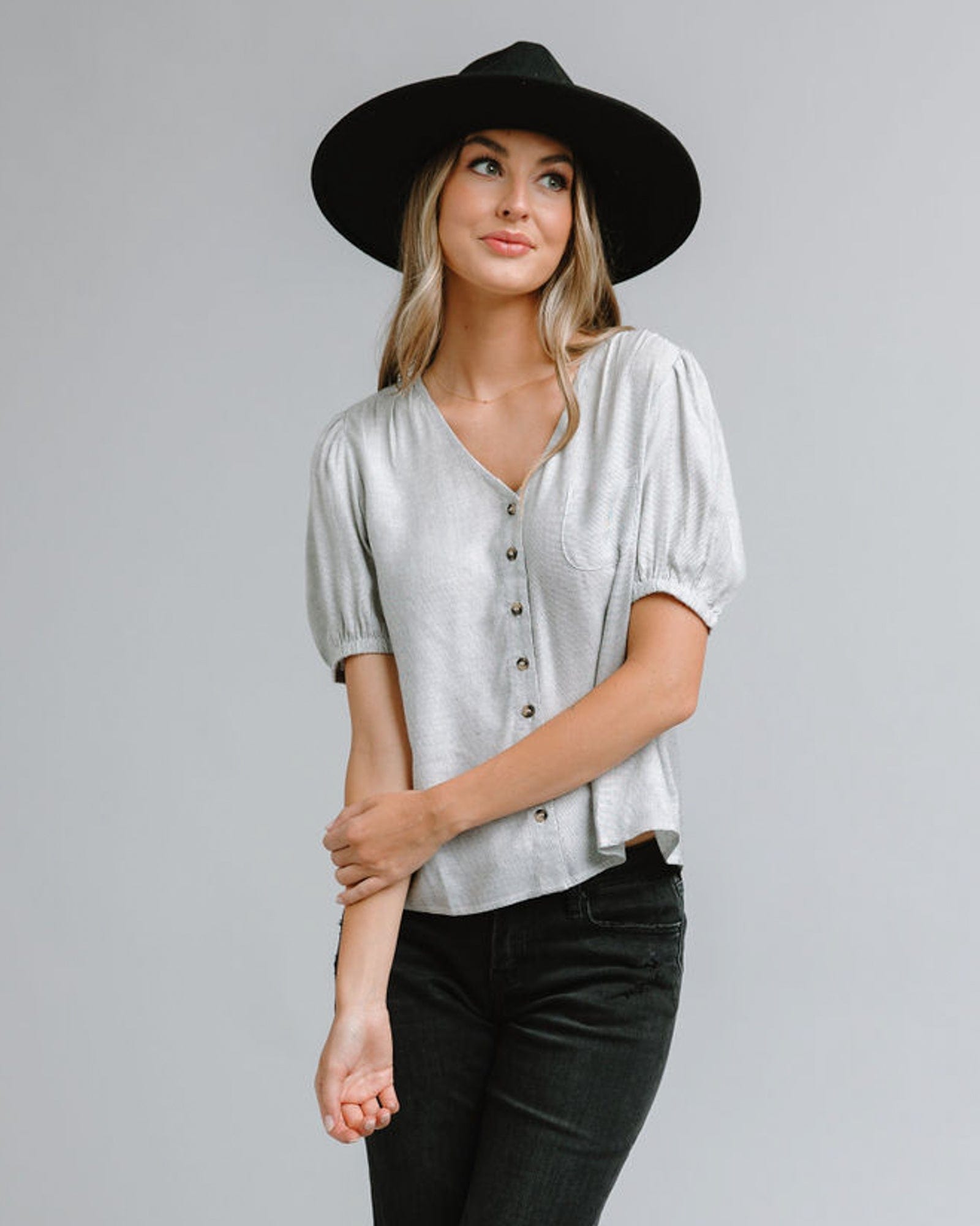 Woman in a short sleeve, v-neck blouse with front buttons