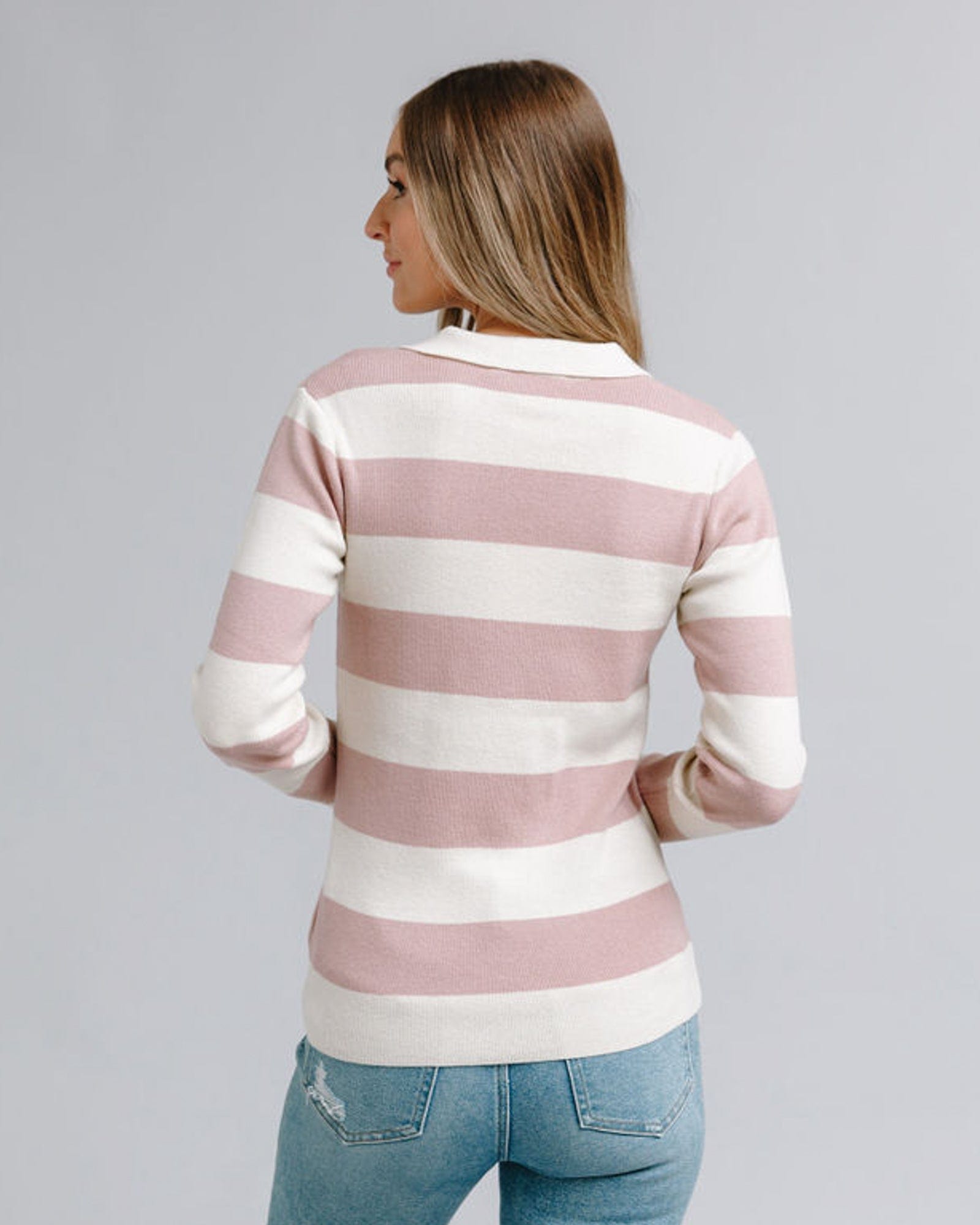 Woman in a striped long sleeve, collared sweater