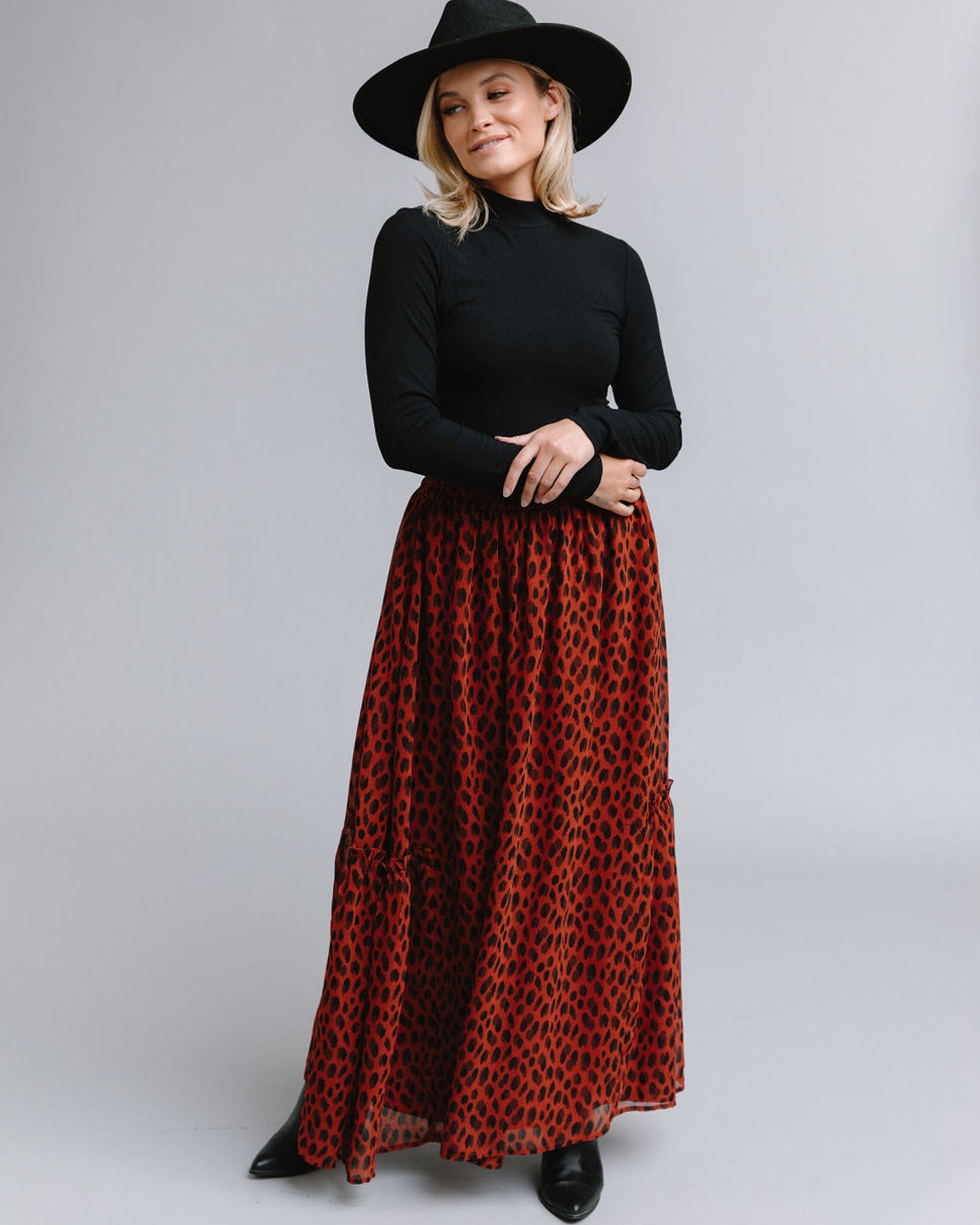 Woman in a maxi-length skirt with an animal print design