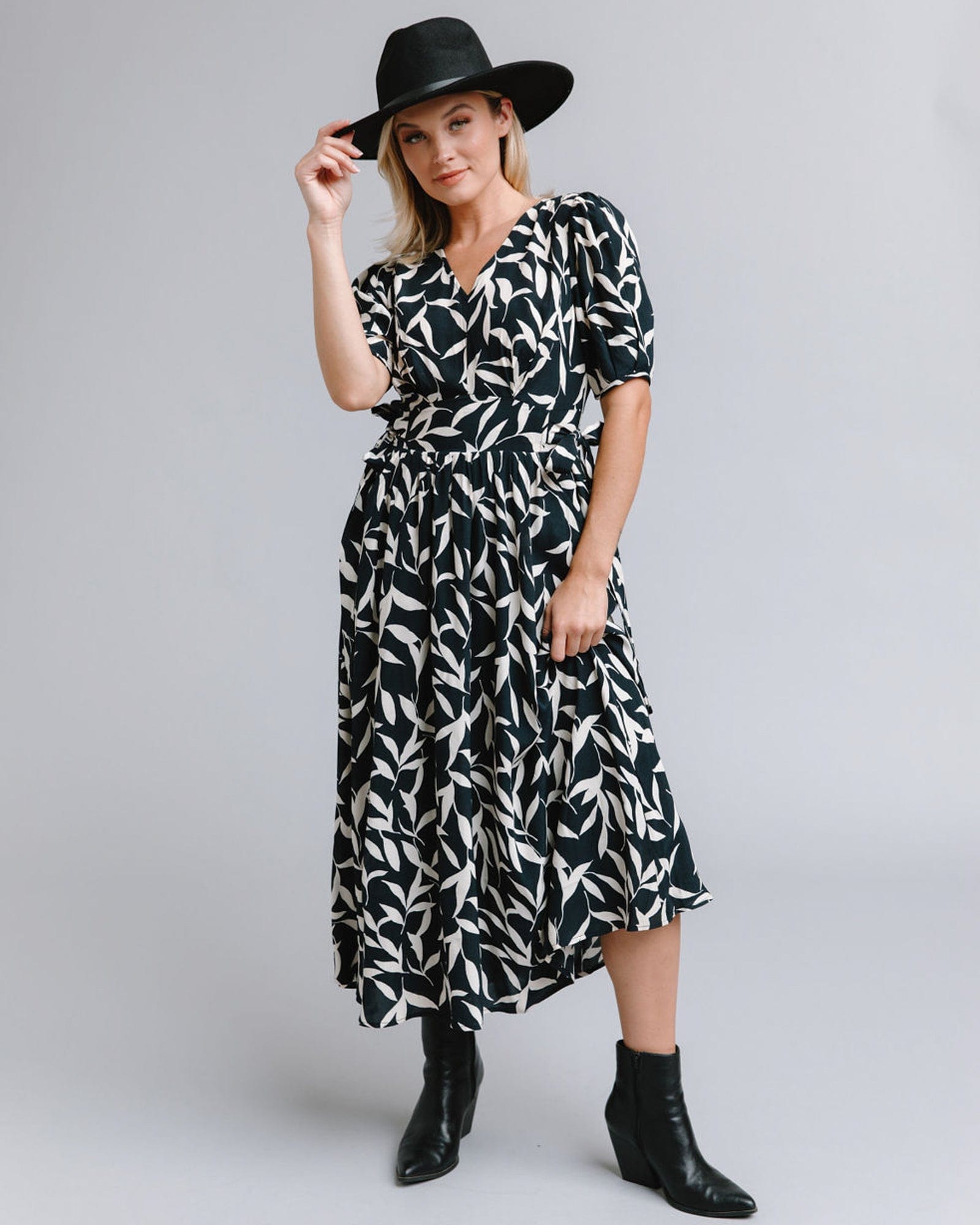Woman in a short sleeve, midi-length, black and white print dress