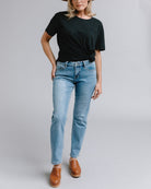 Woman in blue mid-rise straight jeans