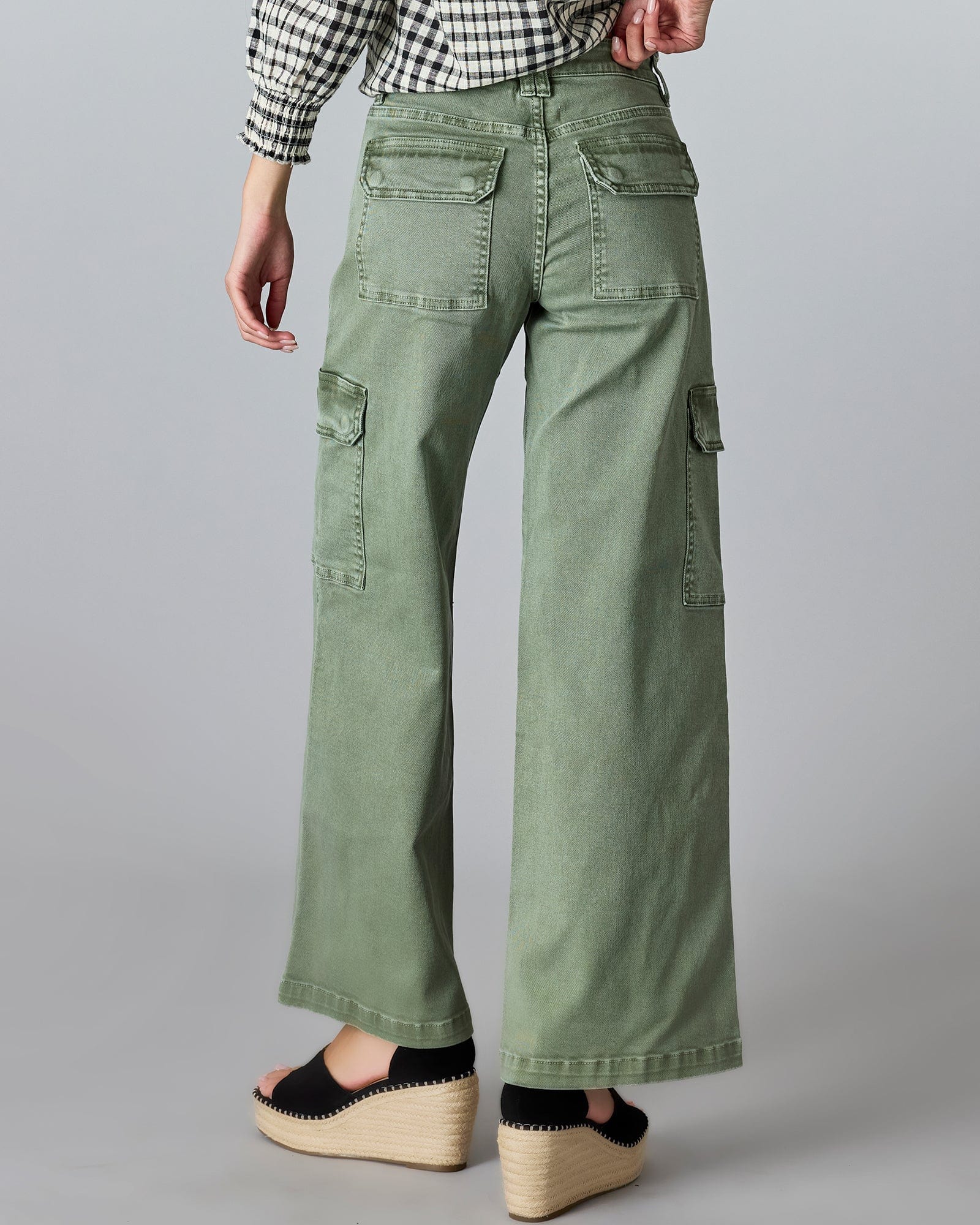 Woman in floor length green cargo jeans.