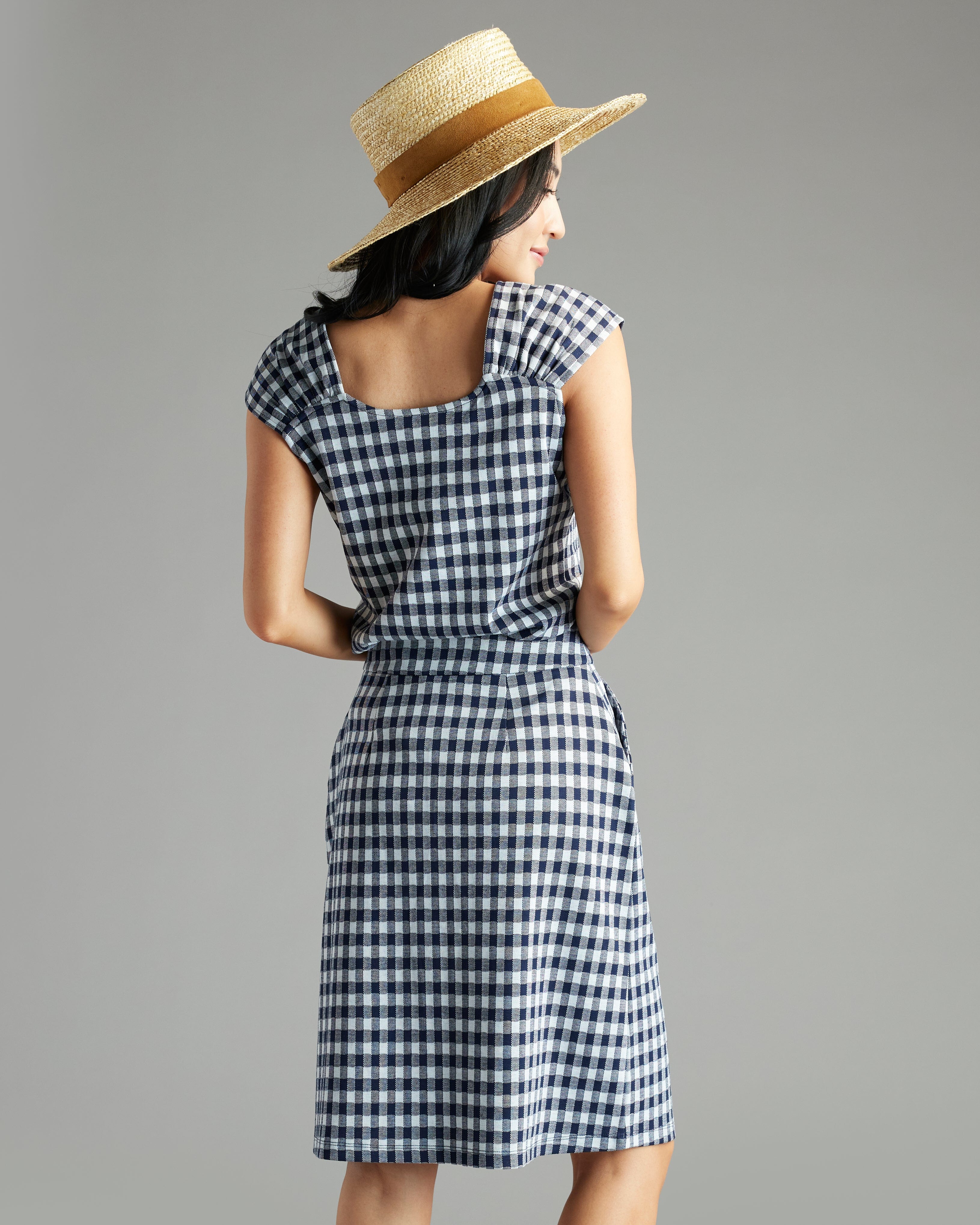 Woman in navy and white gingham knee-length skirt