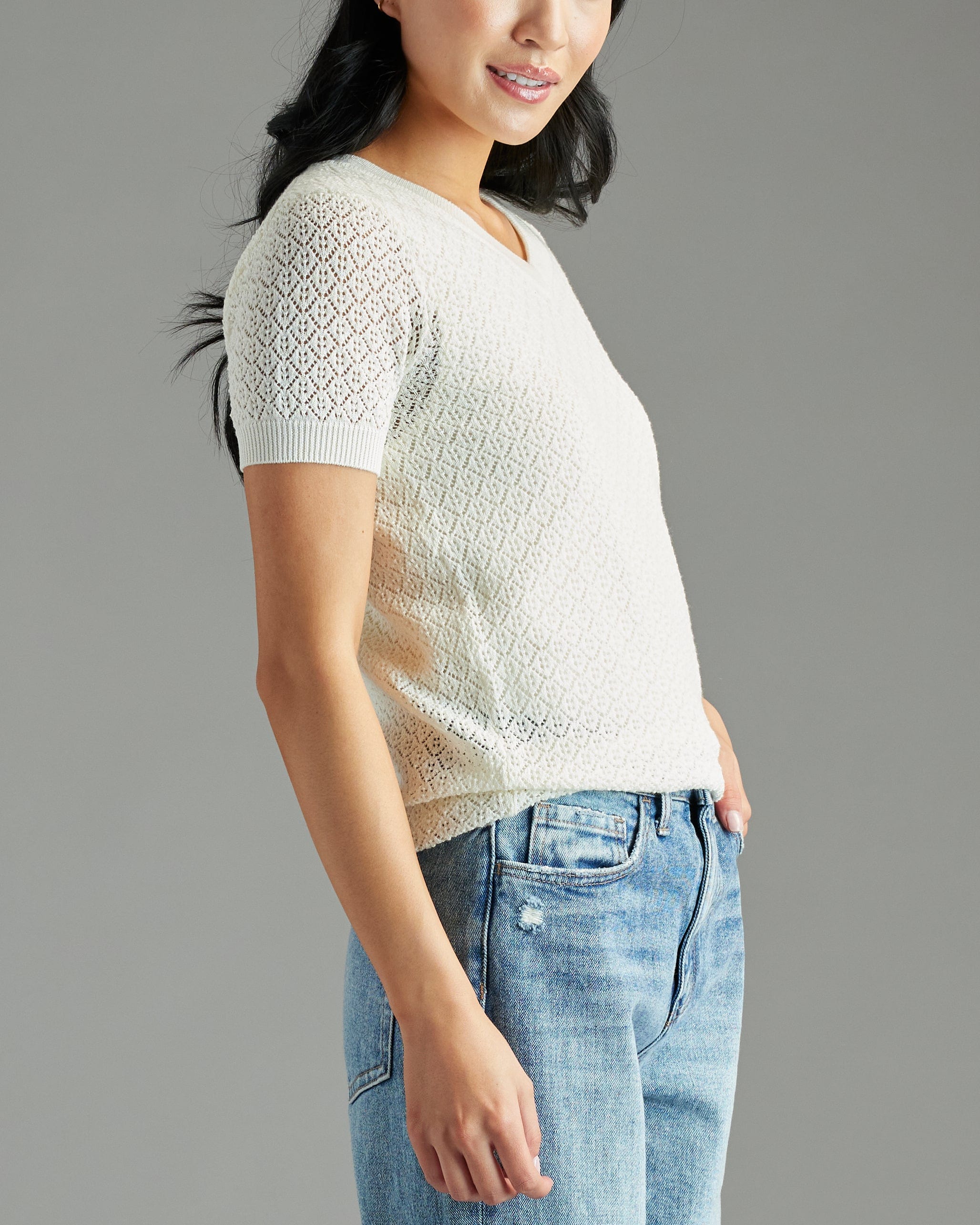 Woman in a white textured short sleeve sweater