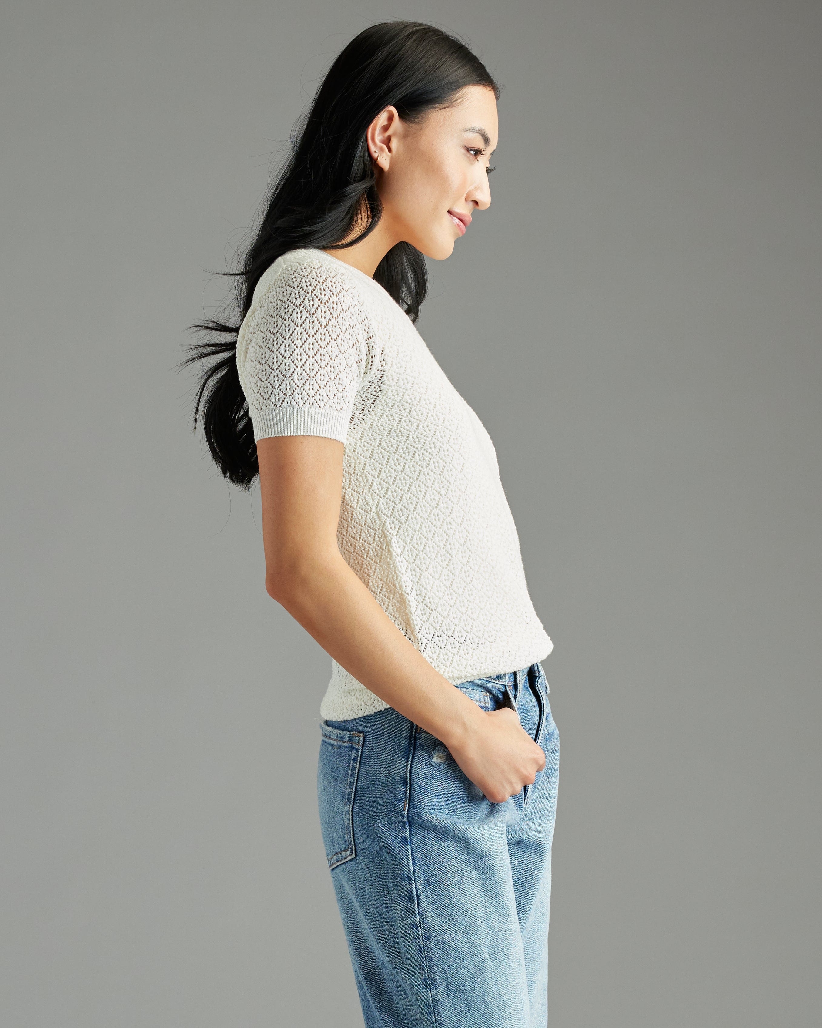 Woman in a white textured short sleeve sweater
