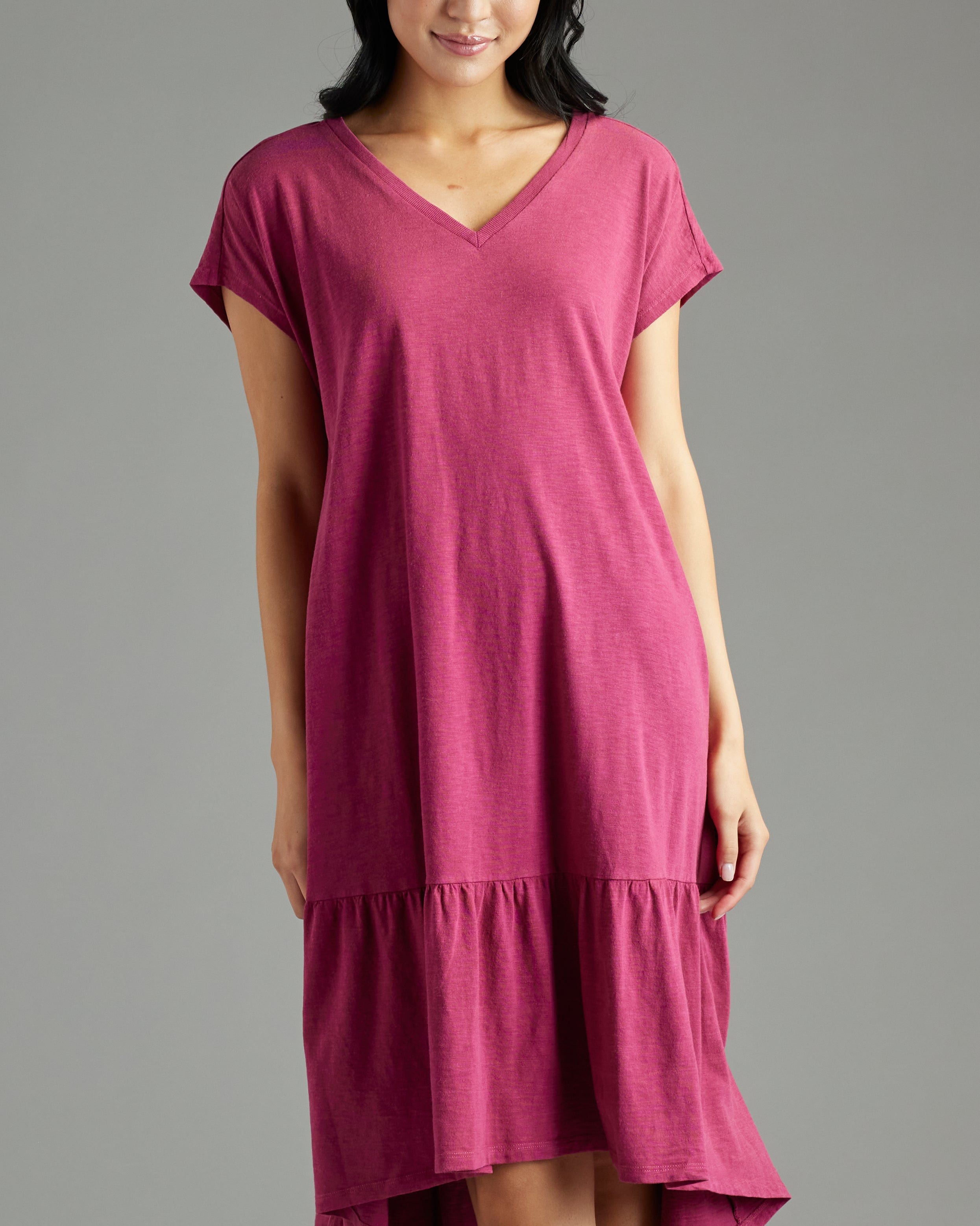 Woman in a short sleeve, v-neck, high-low hem, purple dress