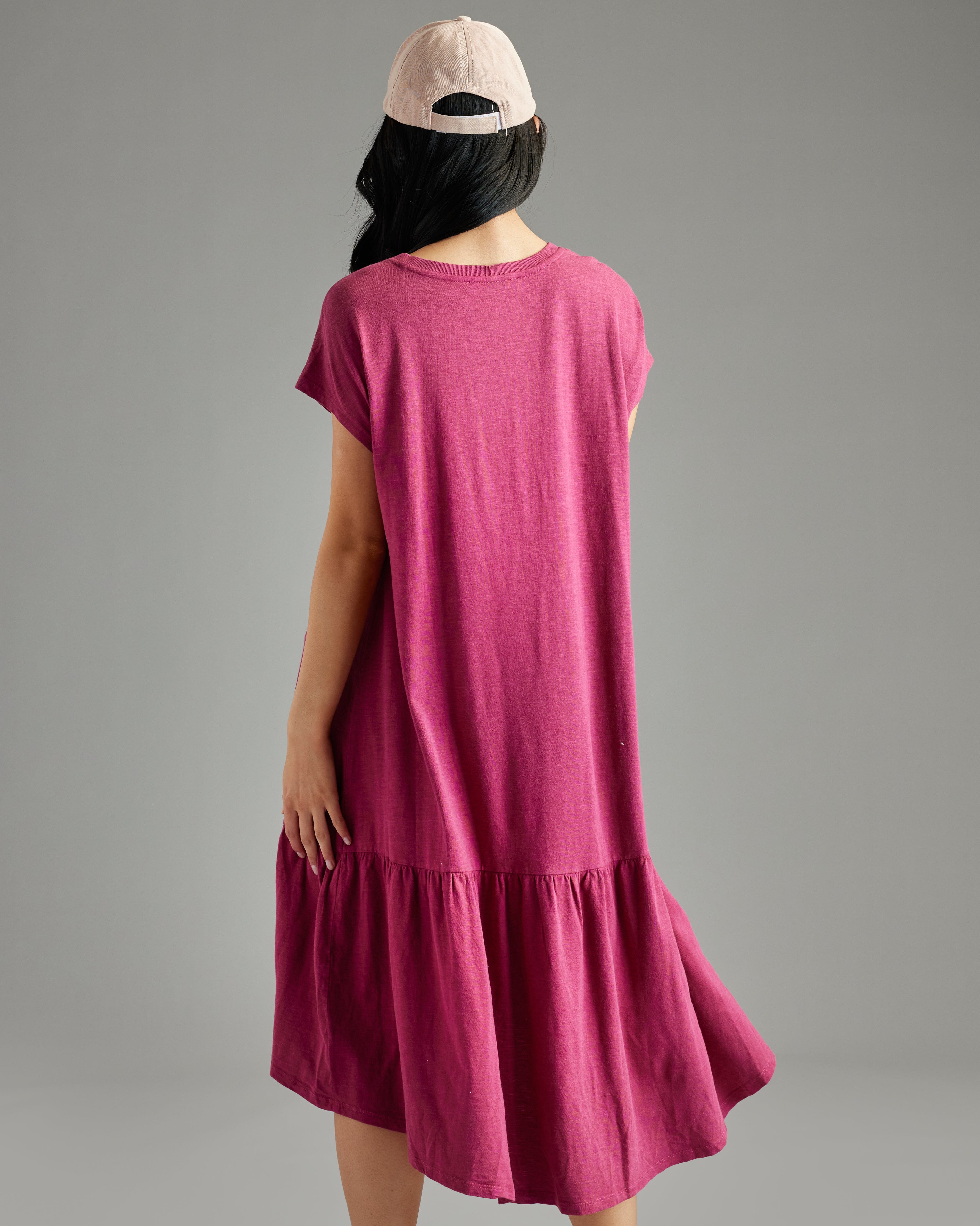 Woman in a short sleeve, v-neck, high-low hem, purple dress