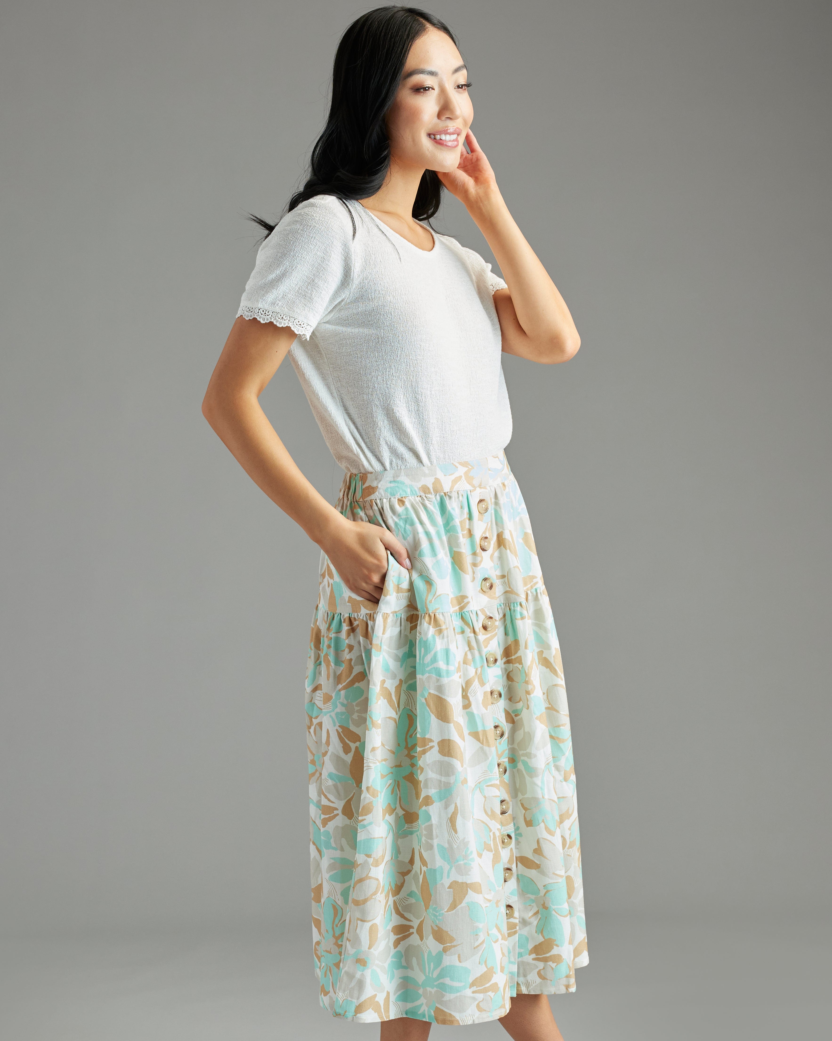 Woman in blue and brown floral print button down skirt