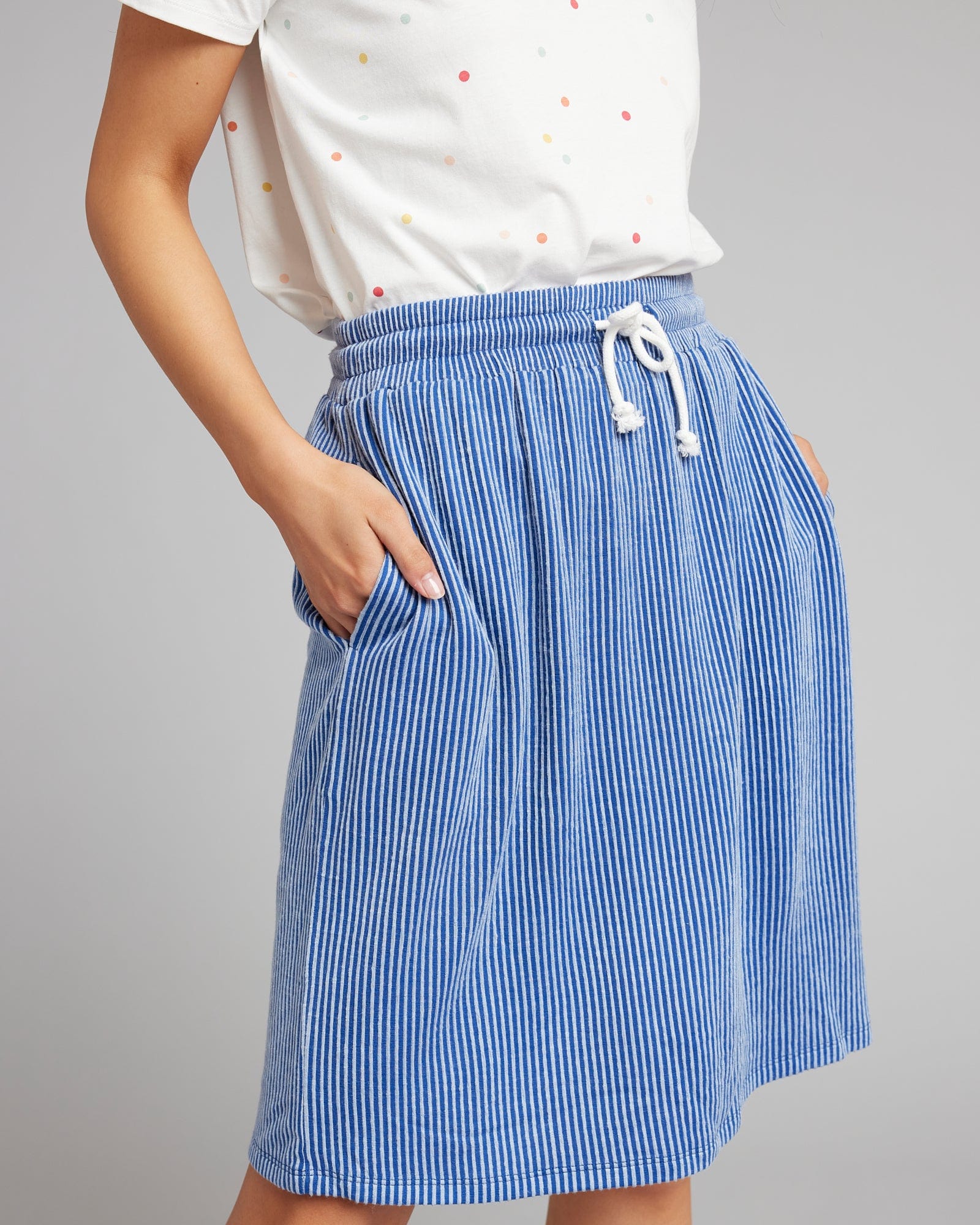 Woman in a blue striped knee-length skirt