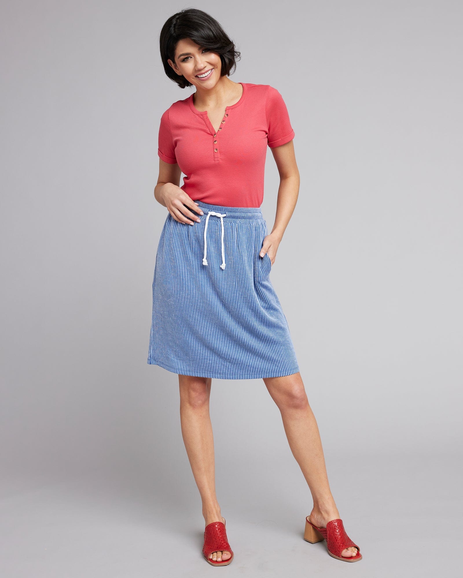Woman in a blue striped knee-length skirt
