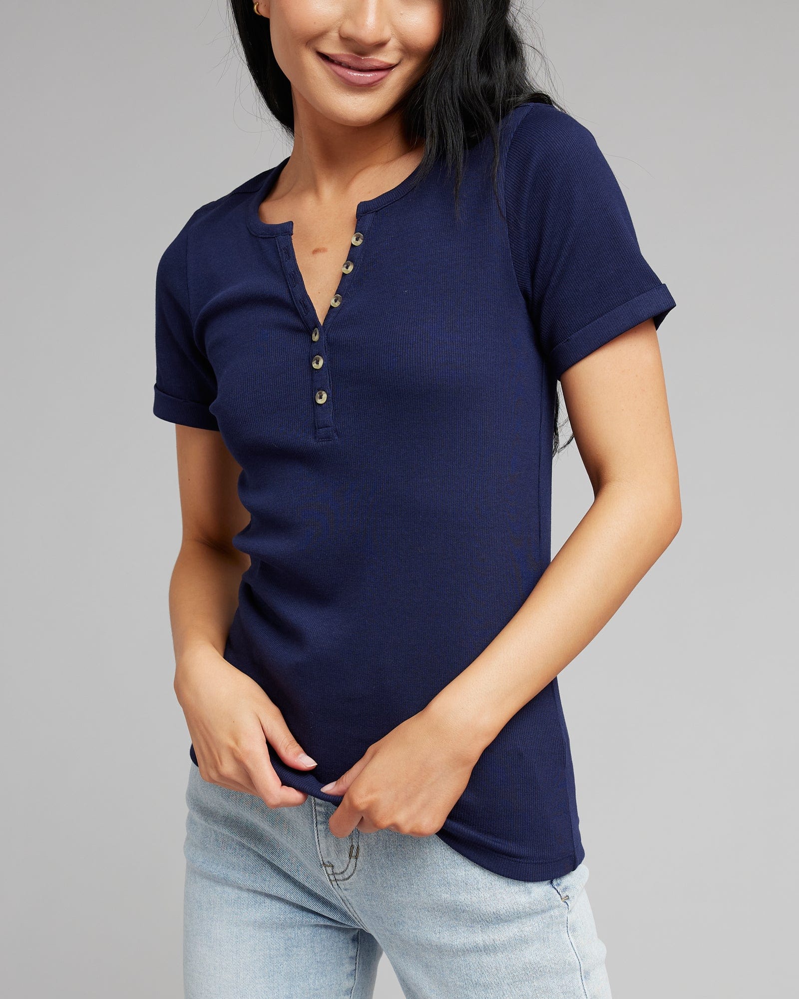Woman in a short sleeved, henley top