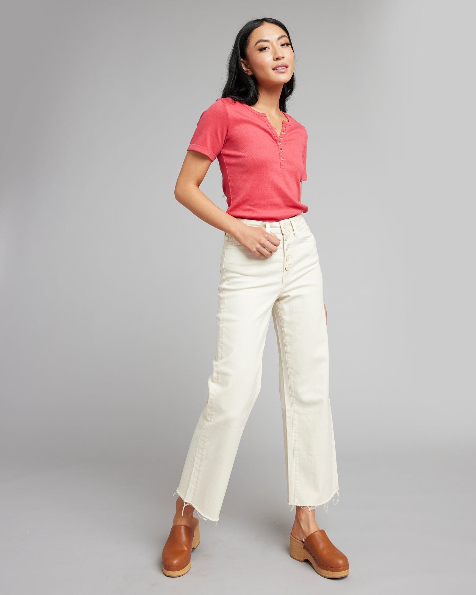 Woman in white high rise cropped denim pants.