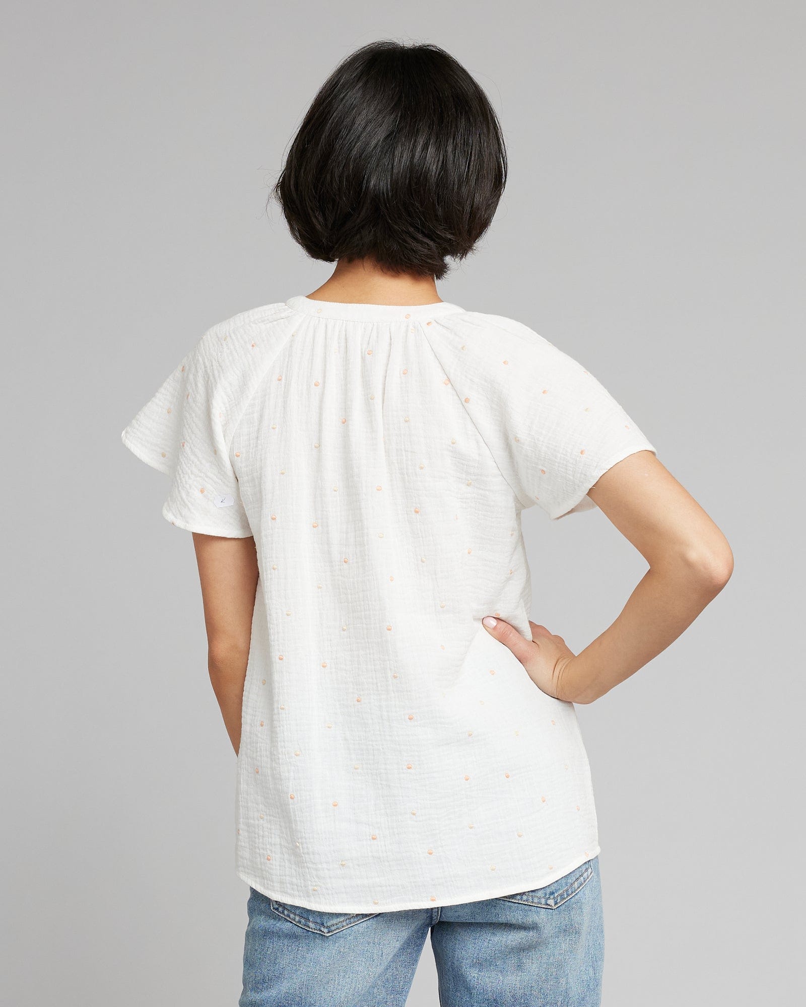 Woman in a short sleeve, v-neck with buttons top