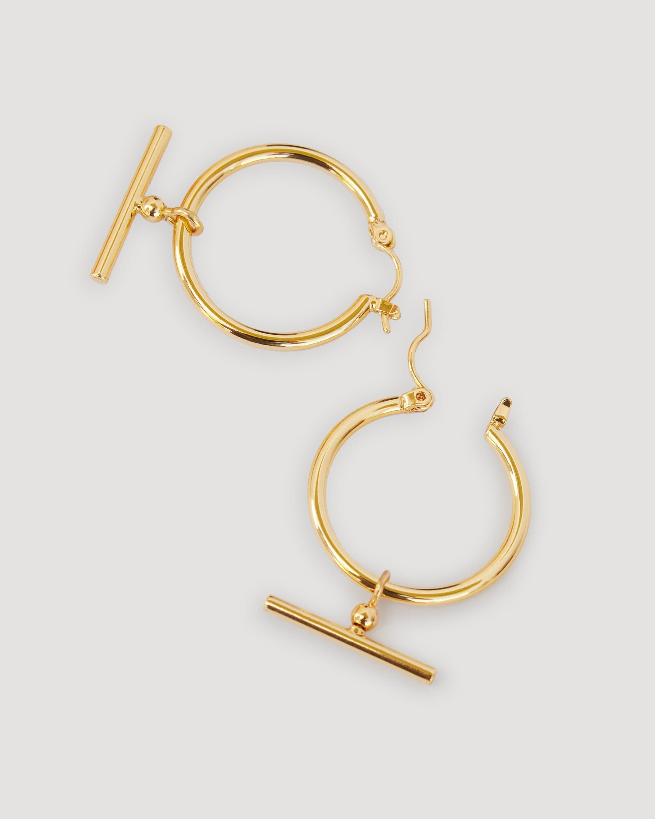 Gold huggie hoops with t-bar in middle
