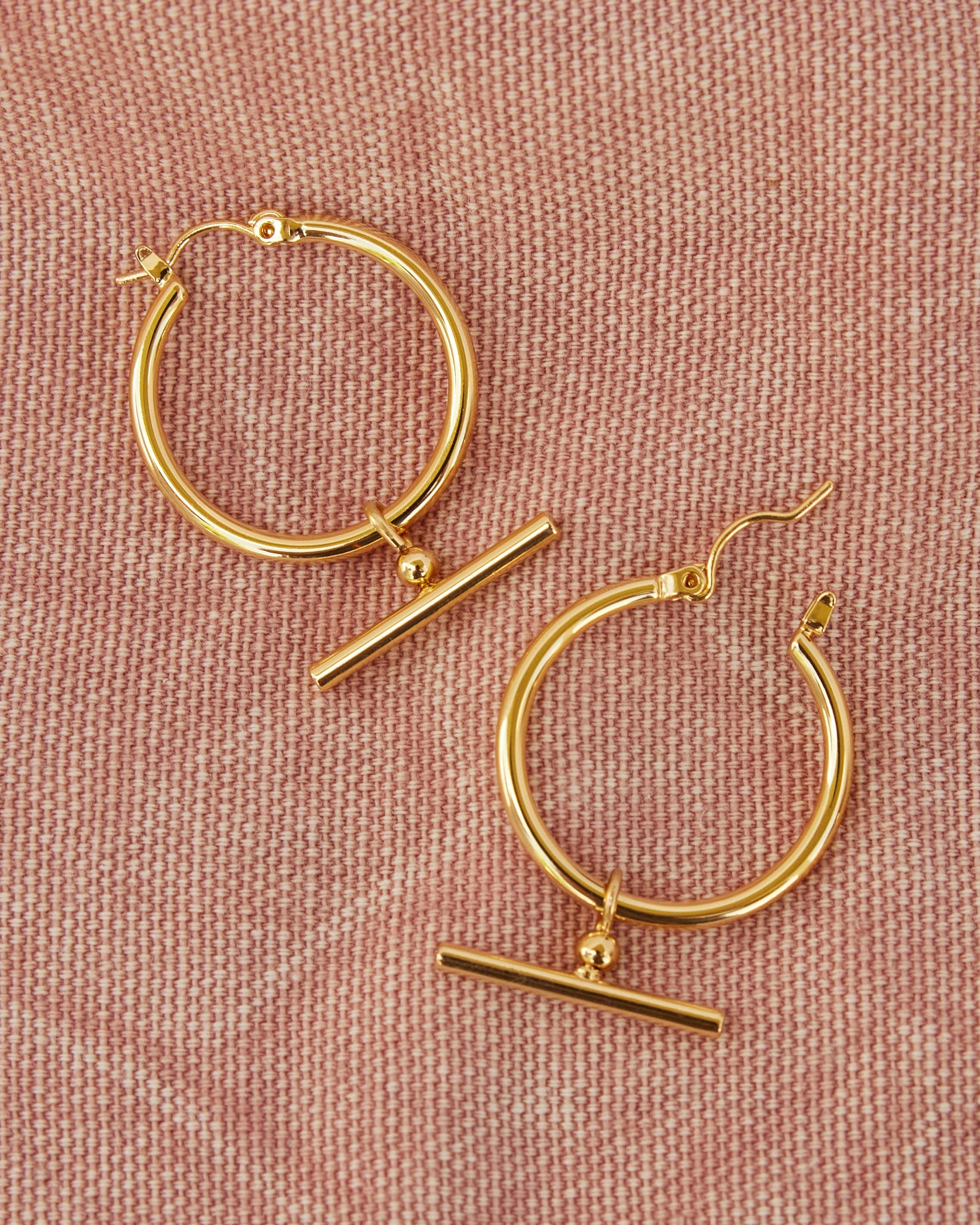 Gold huggie hoops with t-bar in middle