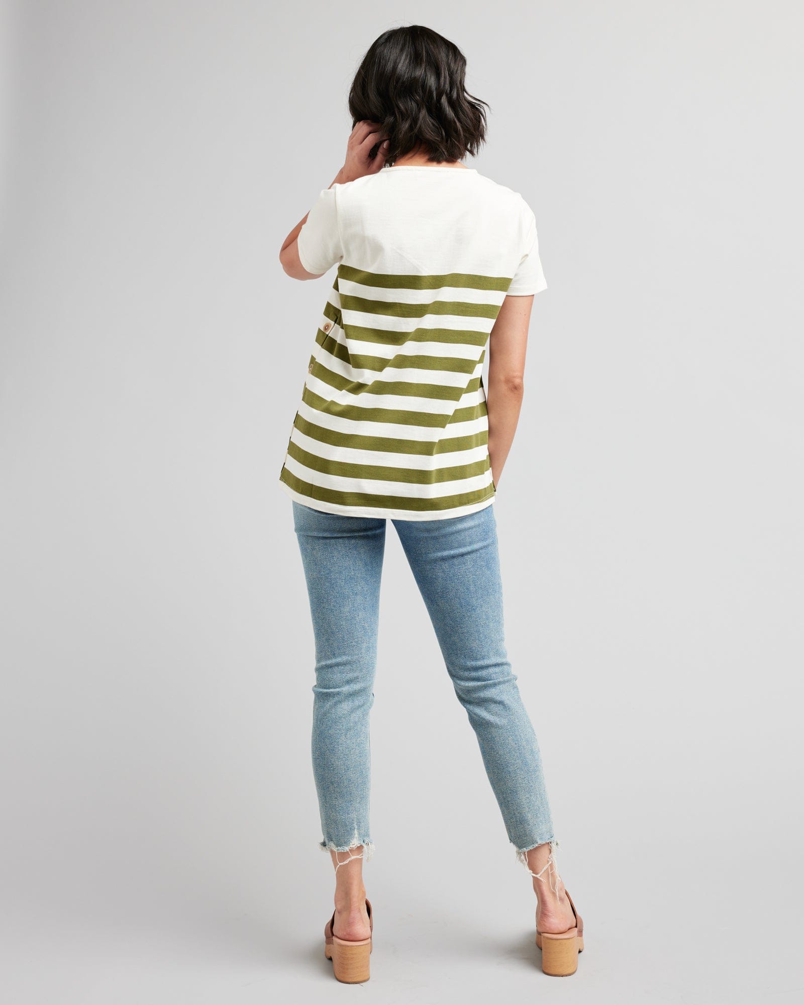Woman in a short sleeve, green and white striped top