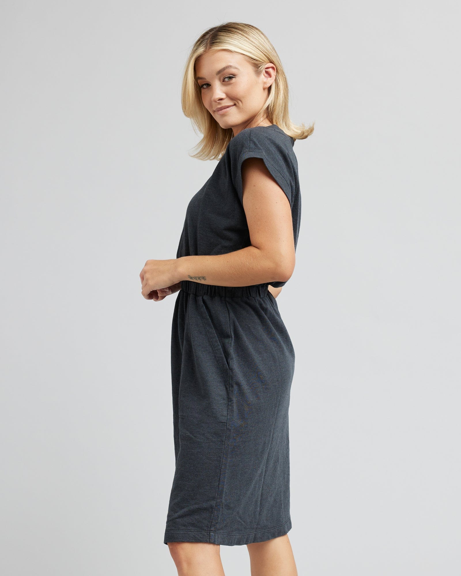 Woman in a short sleeve, v-neck, gray dress
