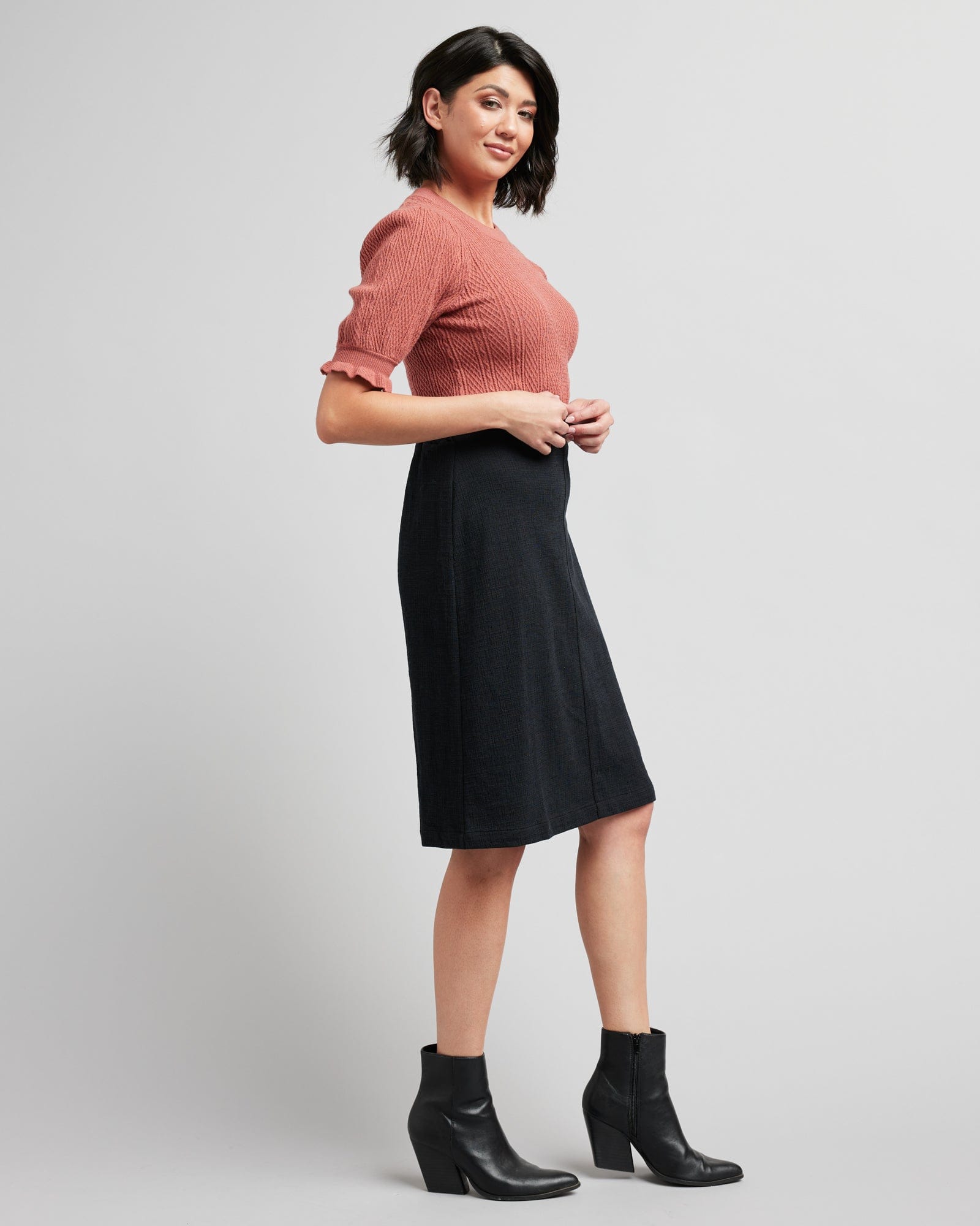 Woman in a black, knee-length pencil skirt