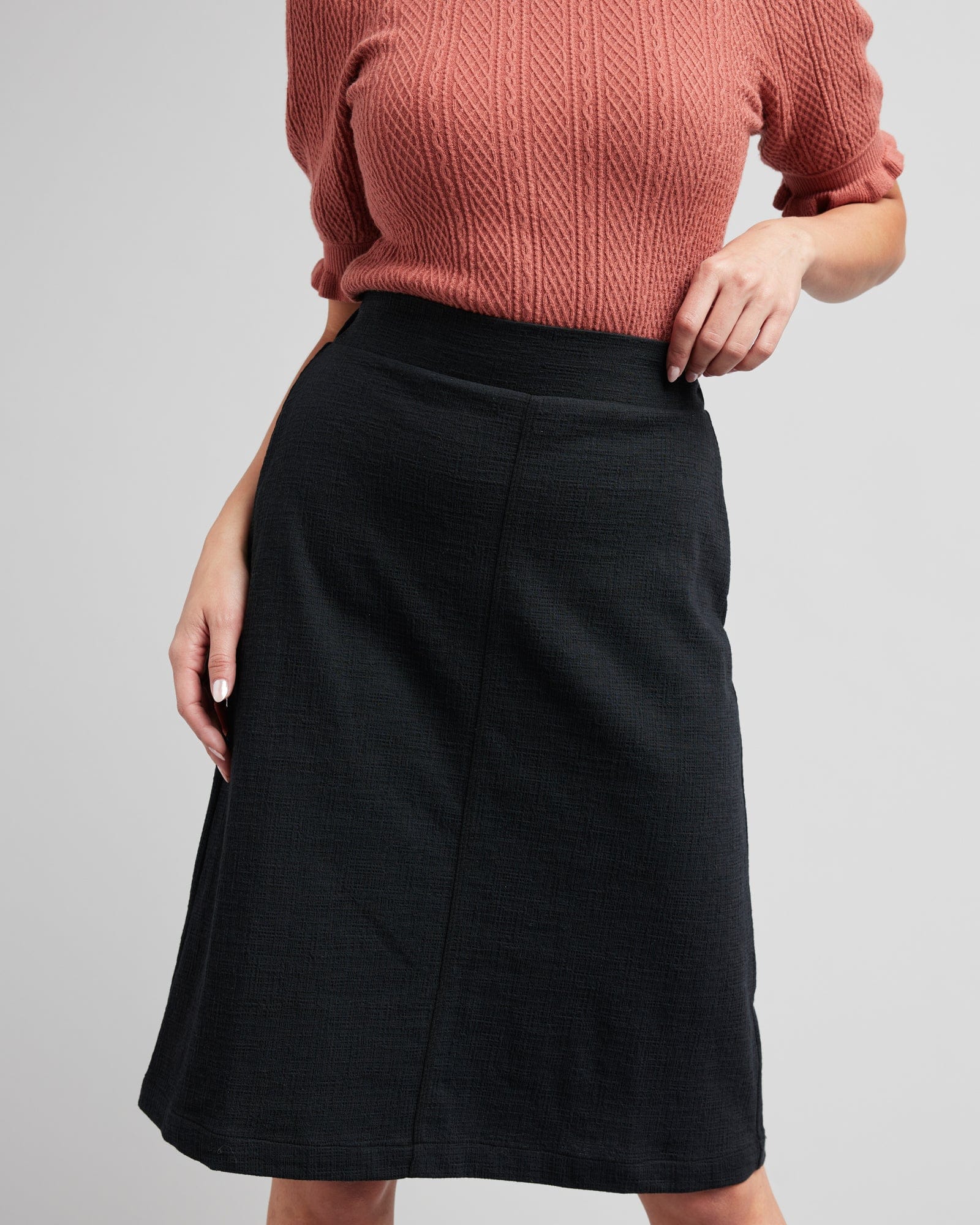 Woman in a black, knee-length pencil skirt