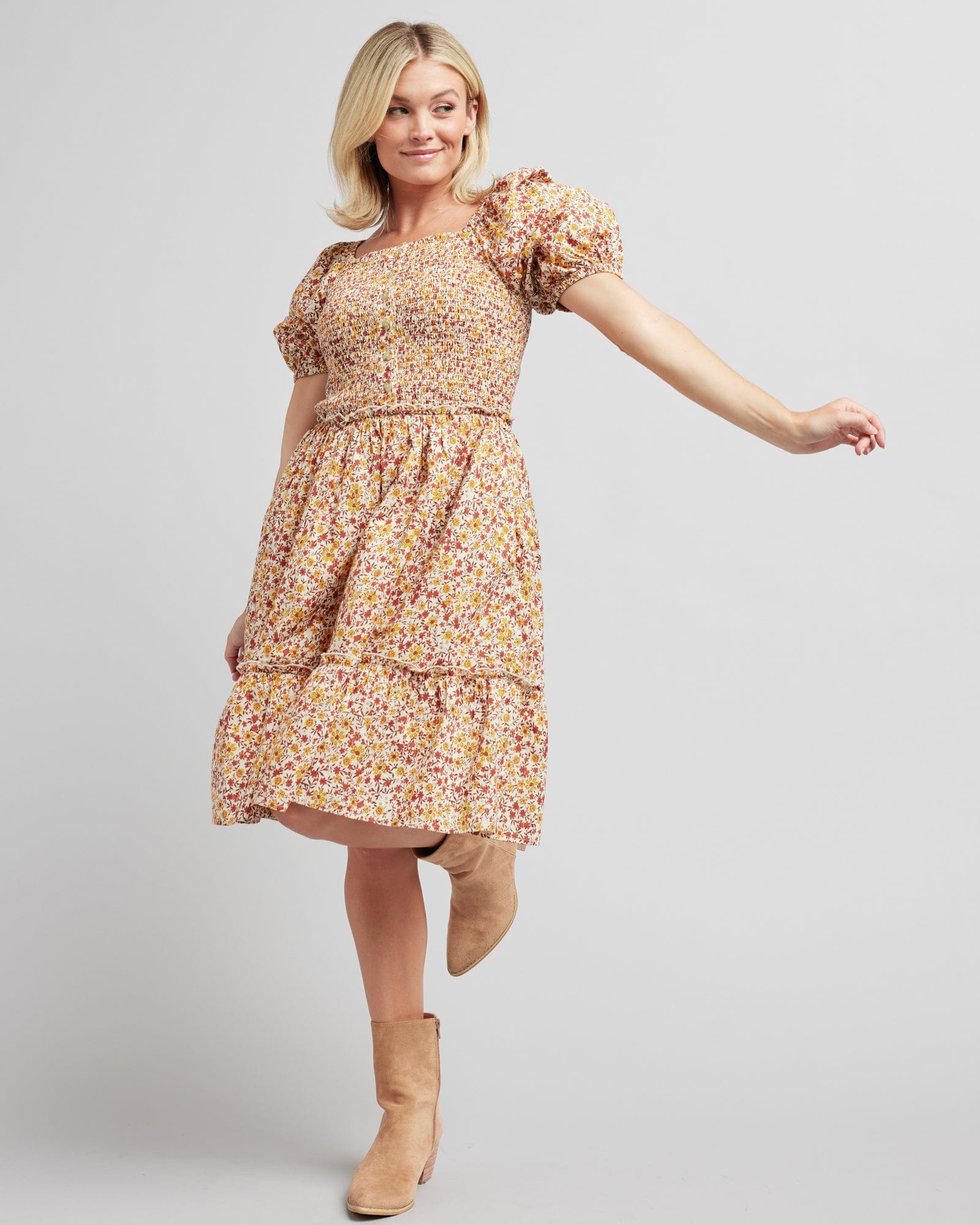 Woman in a short puffed sleeve, knee-length, floral printed dress