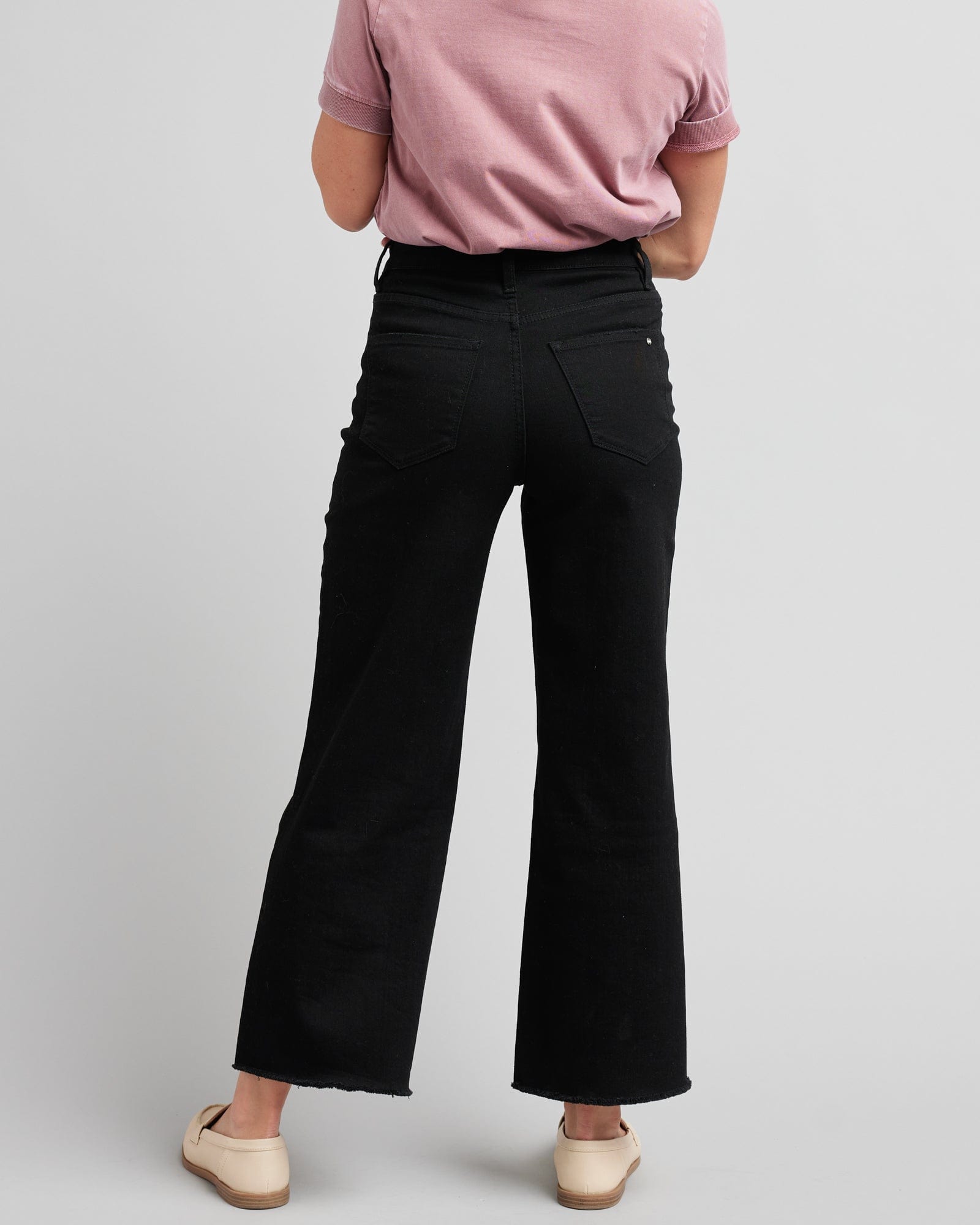 Woman in black wide-leg crop jeans