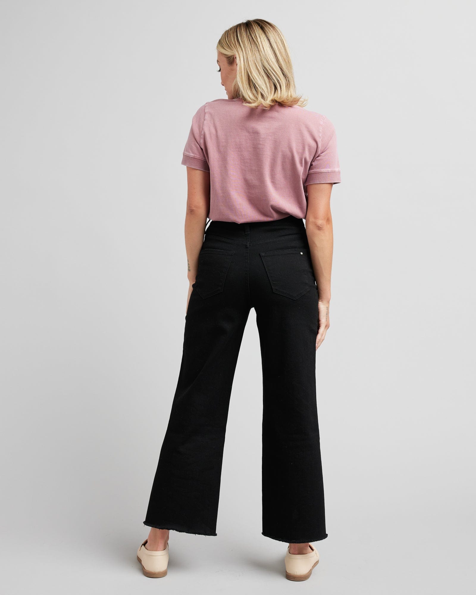 Woman in black wide-leg crop jeans