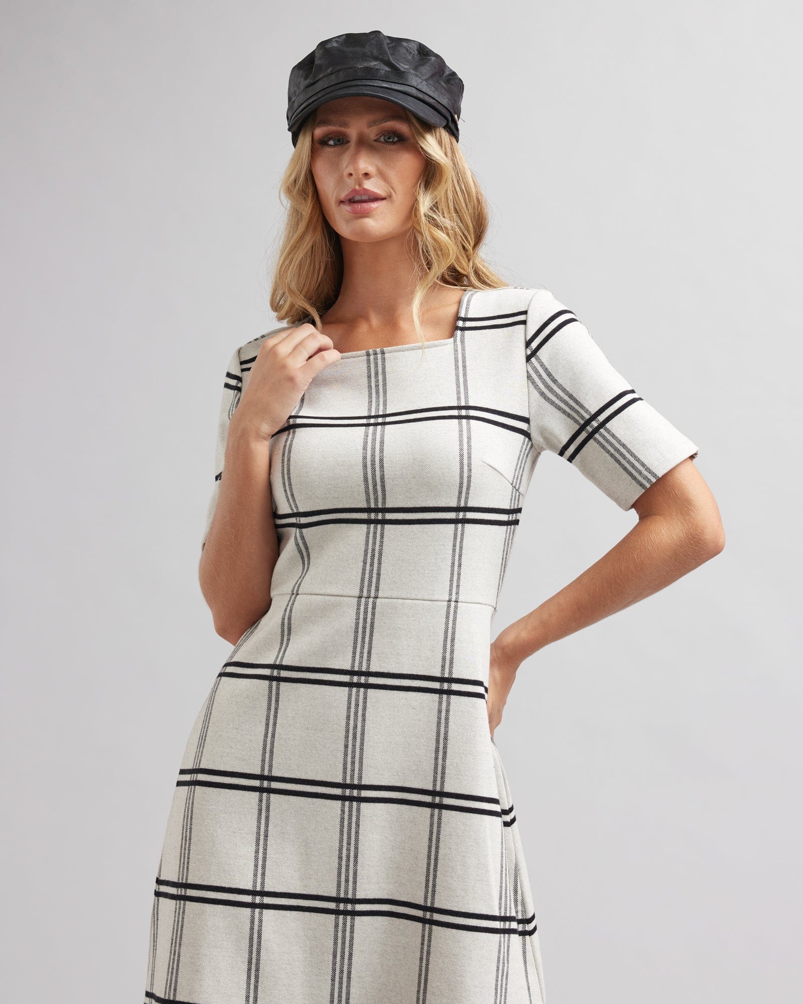 Woman in a half sleeved, knee-length, black and white plaid dress