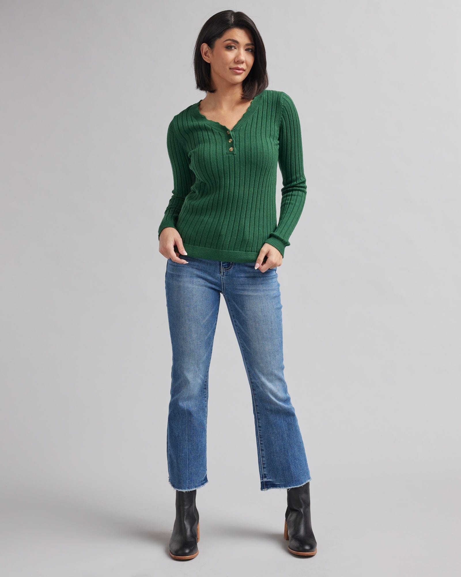 Woman in a long sleeve, green , ribbed sweater