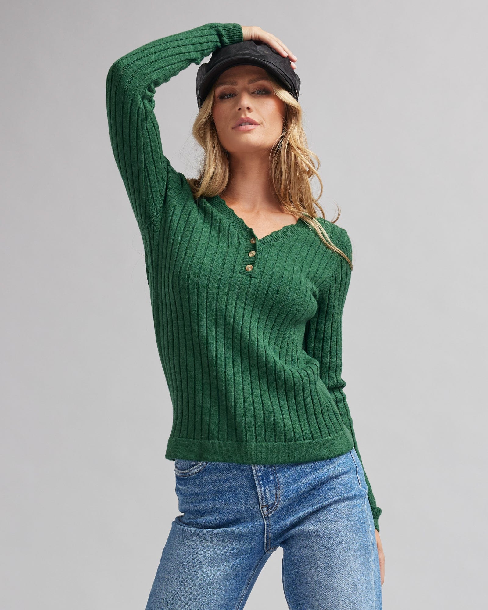 Woman in a long sleeve, green , ribbed sweater