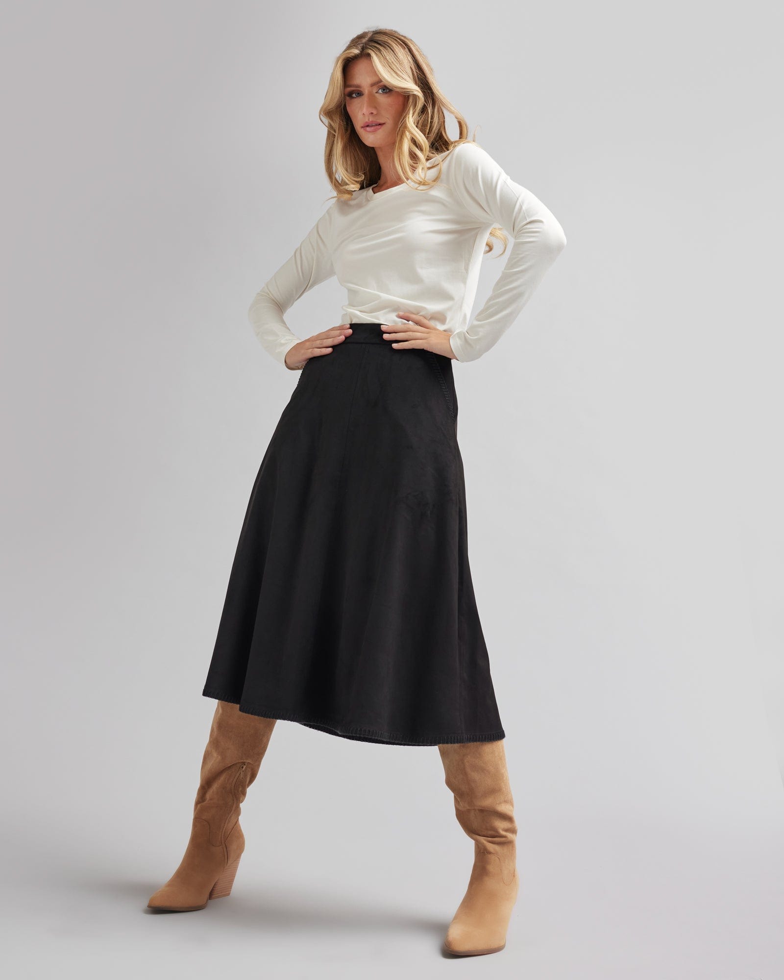 Woman in a black, midi-length, suede skirt