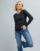 Woman in a long sleeve, ribbed t-shirt