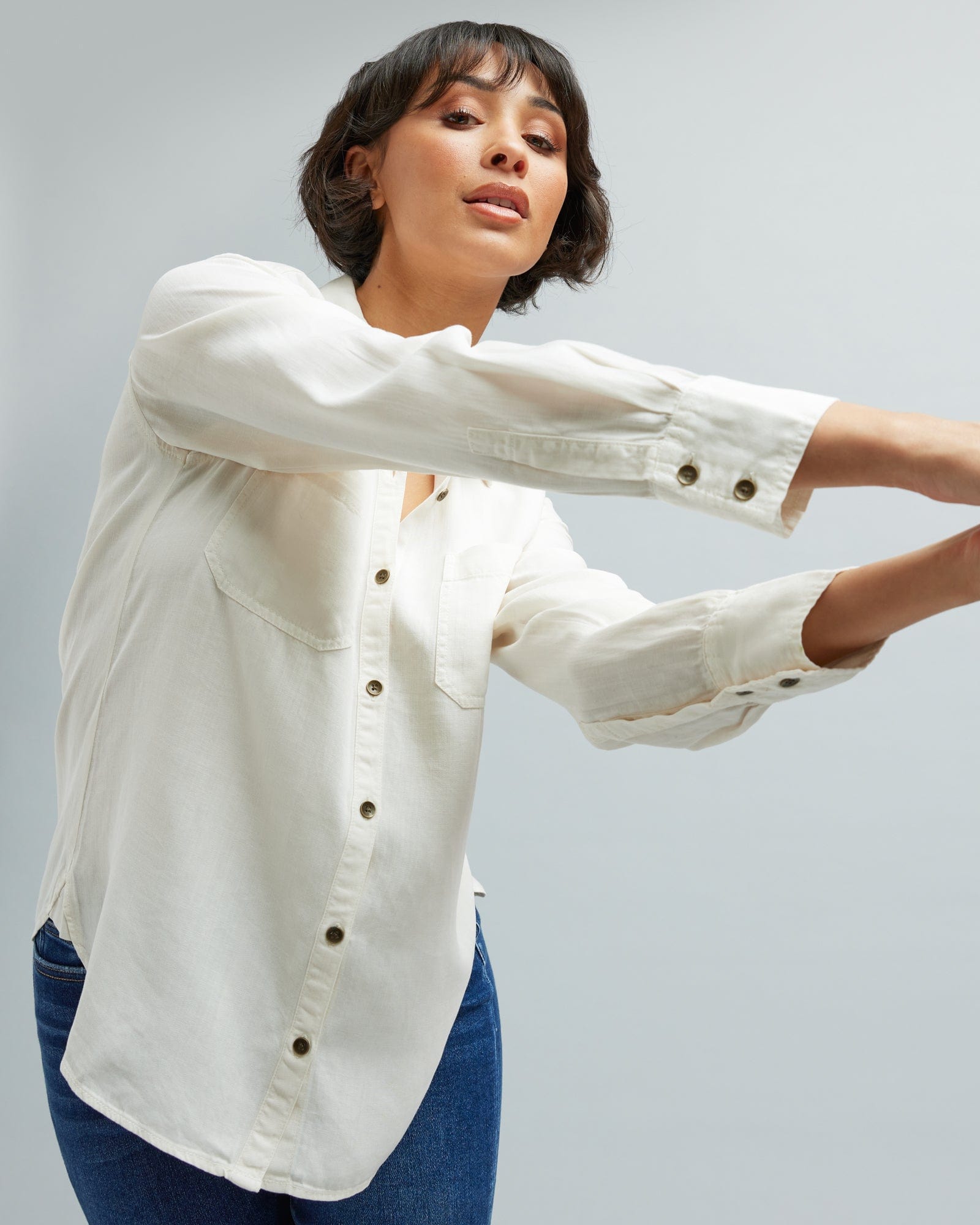 Woman in a long sleeve, white, button-down blouse