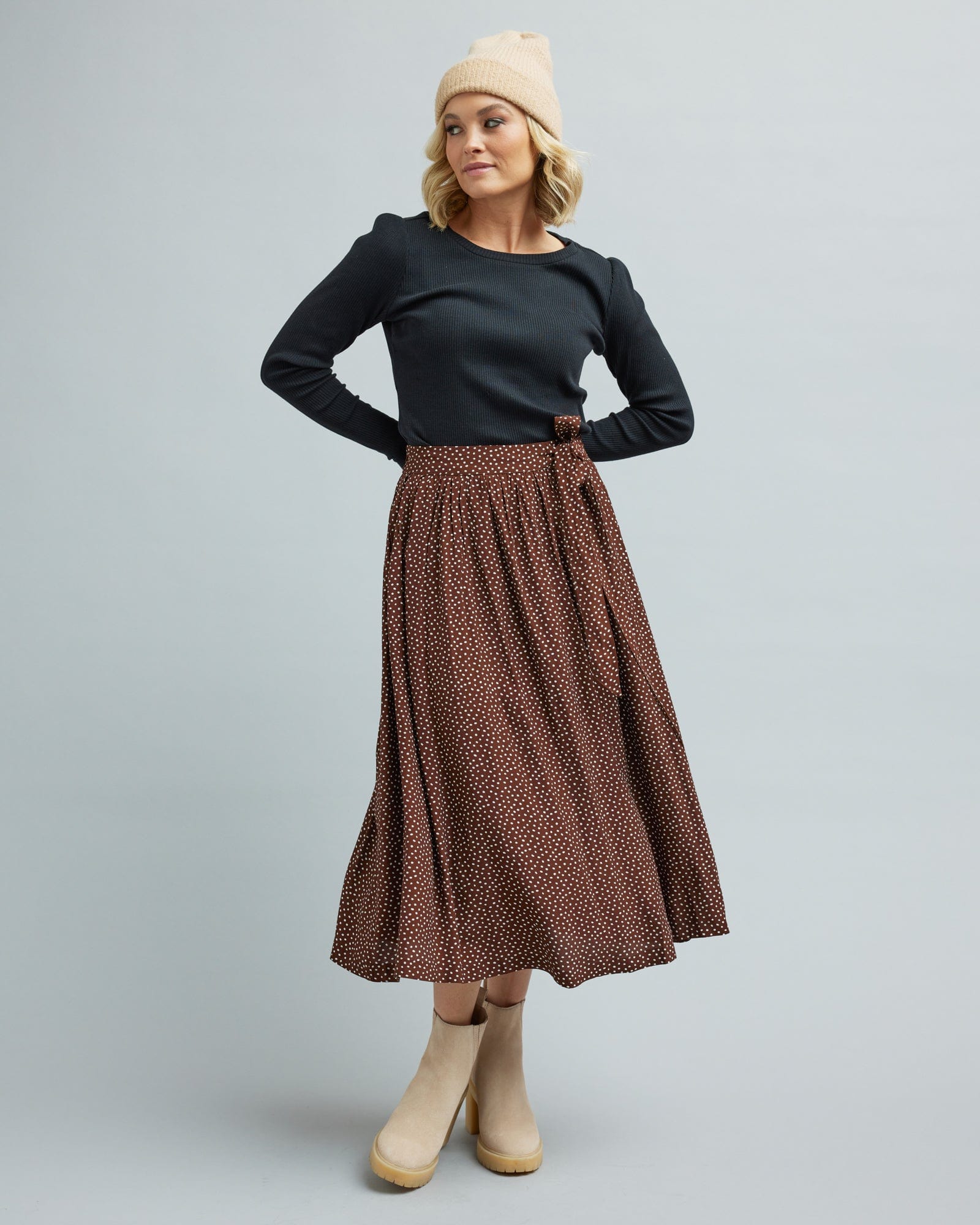 Woman in a brown, midi length skirt