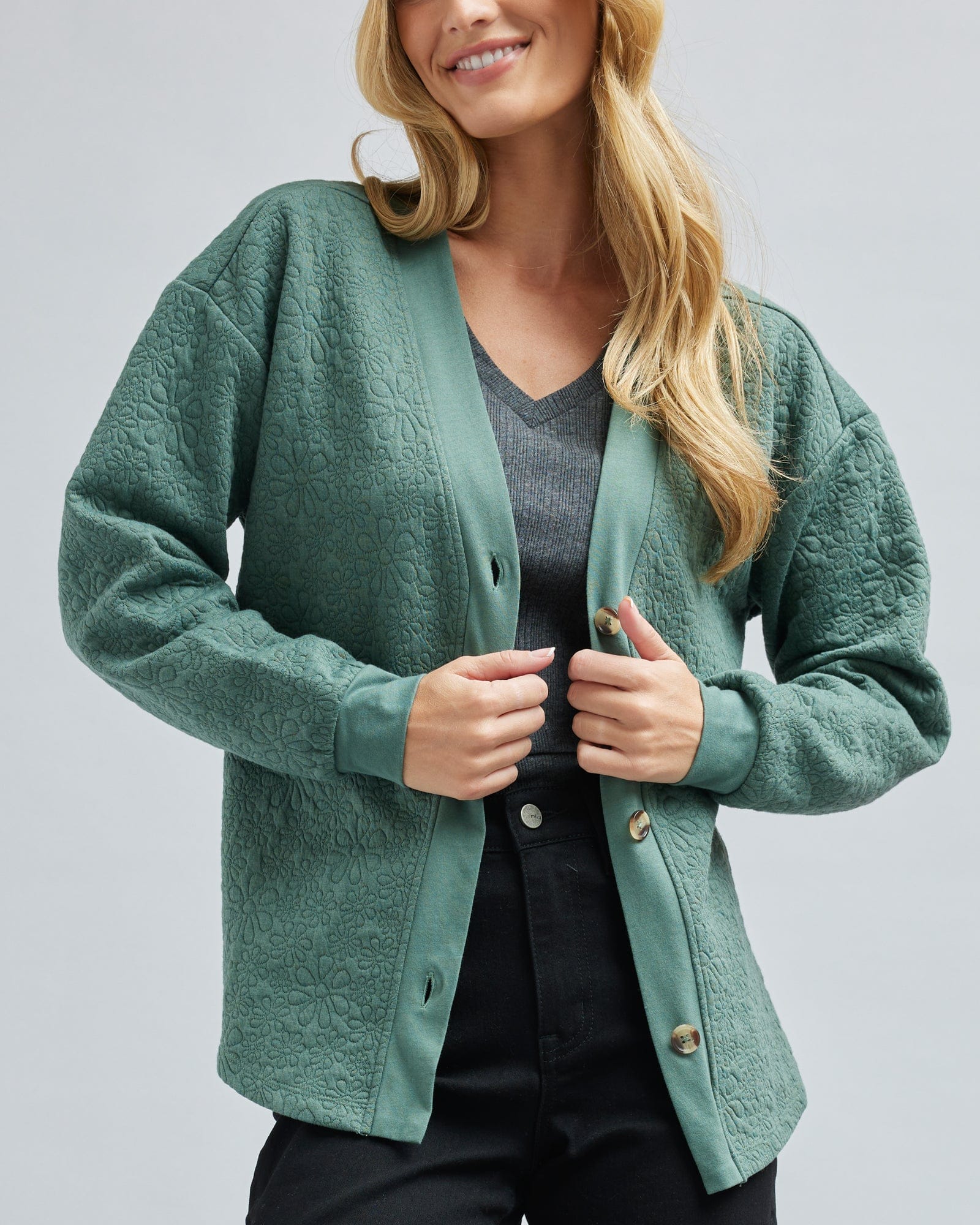 Woman in a long sleeve, quilted cardigan