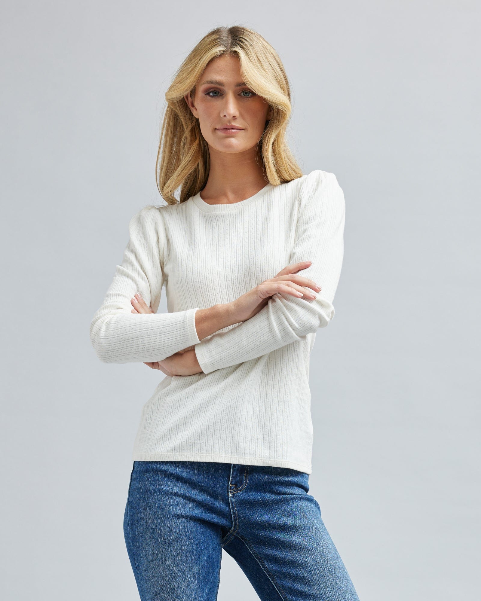 Woman in a long sleeve, ribbed, white t-shirt