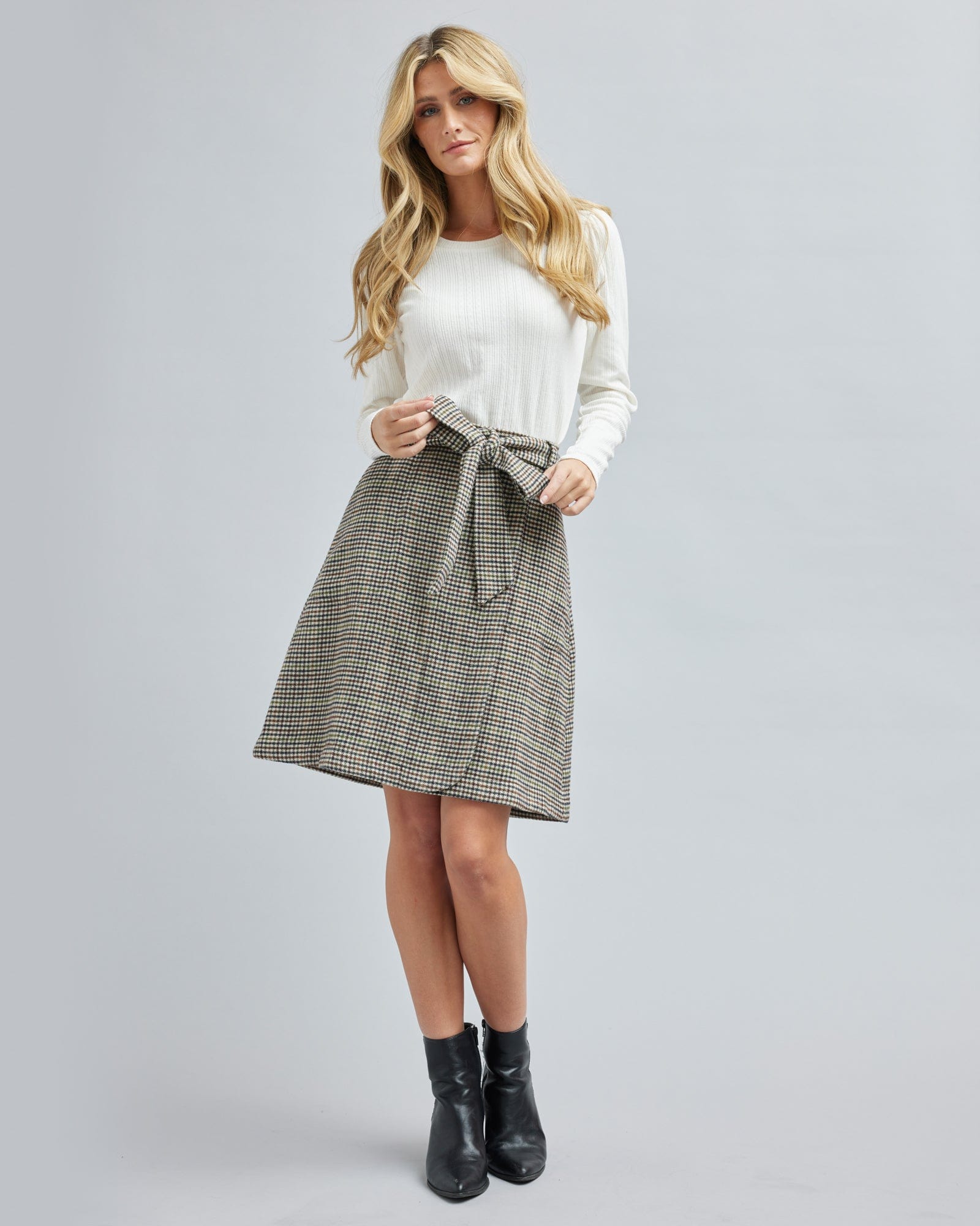 Woman in a plaid, knee-length skirt