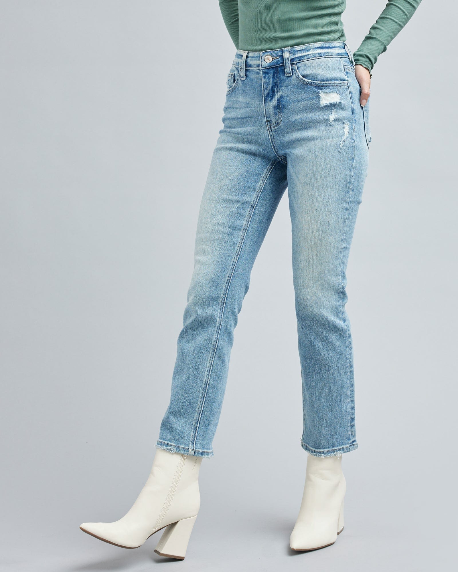Woman in light blue jean, ankle length jean pants.