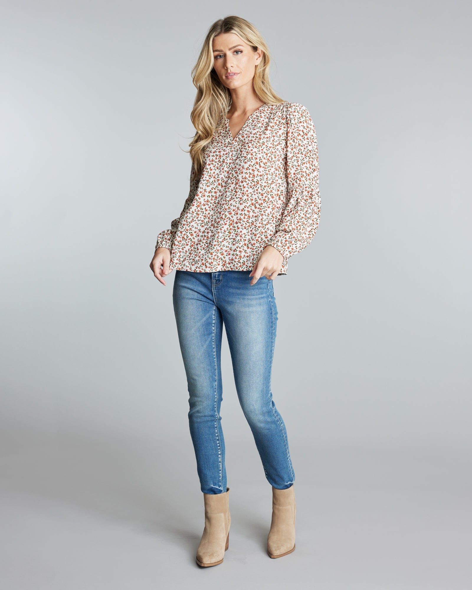 Woman in a long sleeve, floral printed blouse