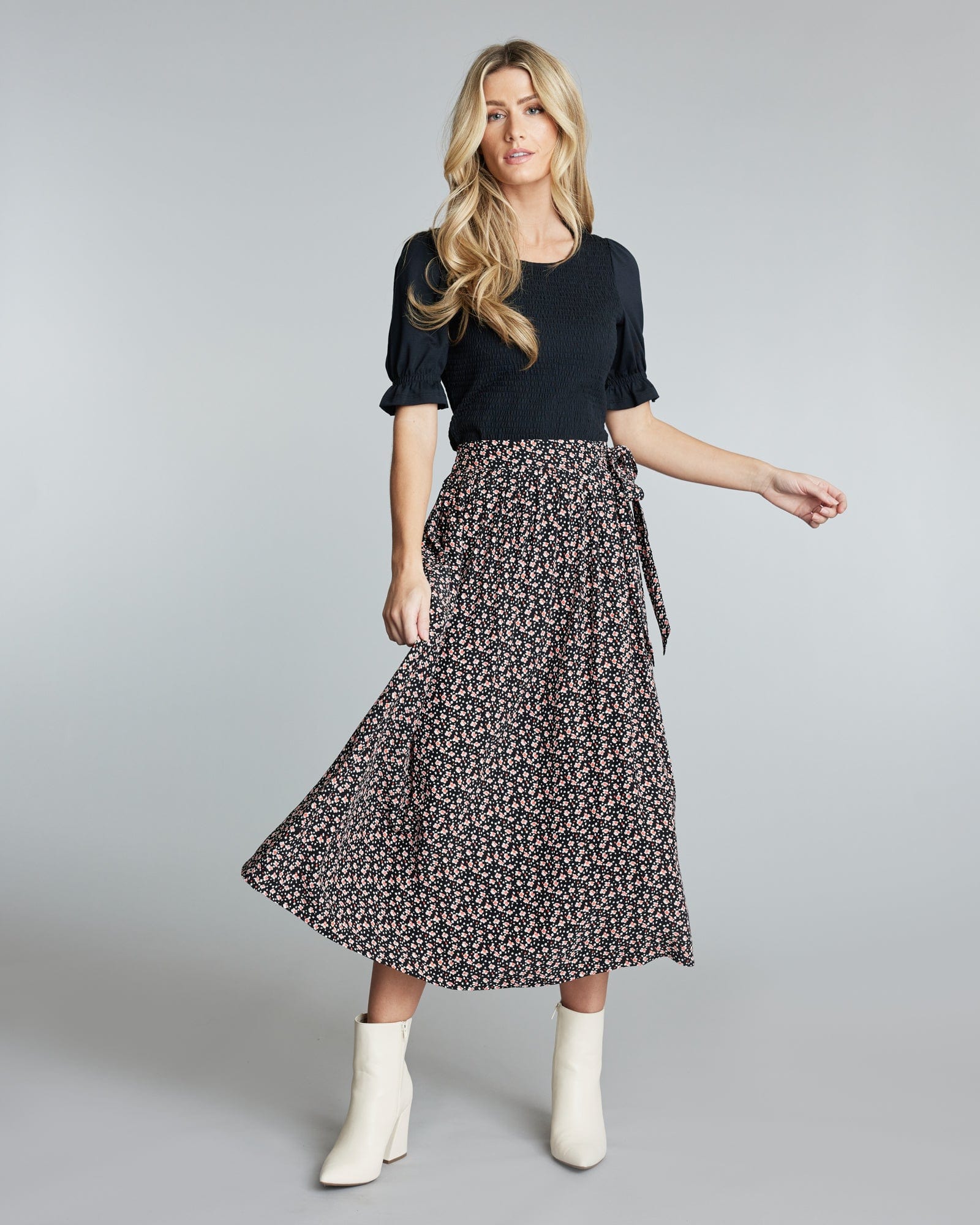 Woman in a midi length floral skirt