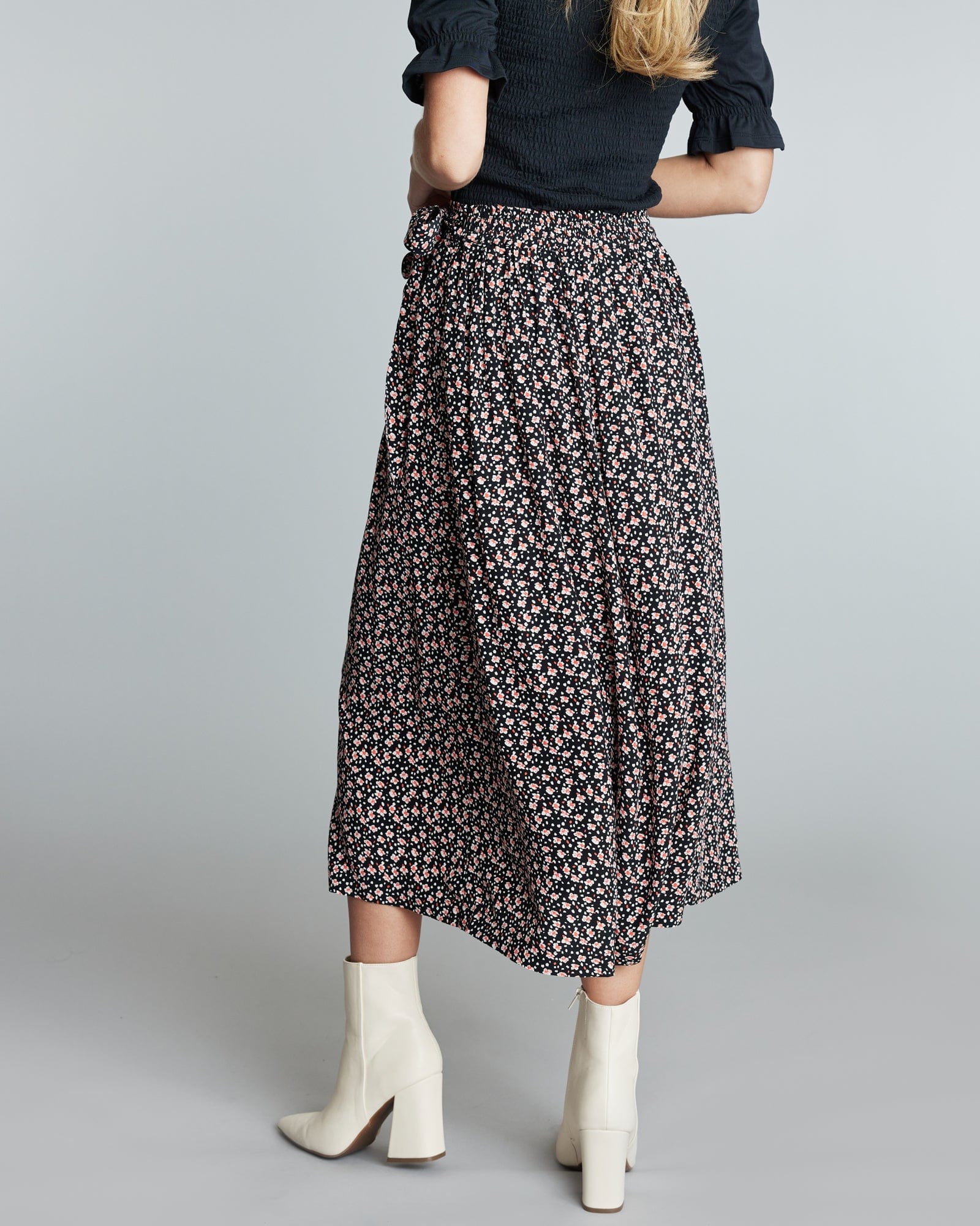 Woman in a midi length floral skirt